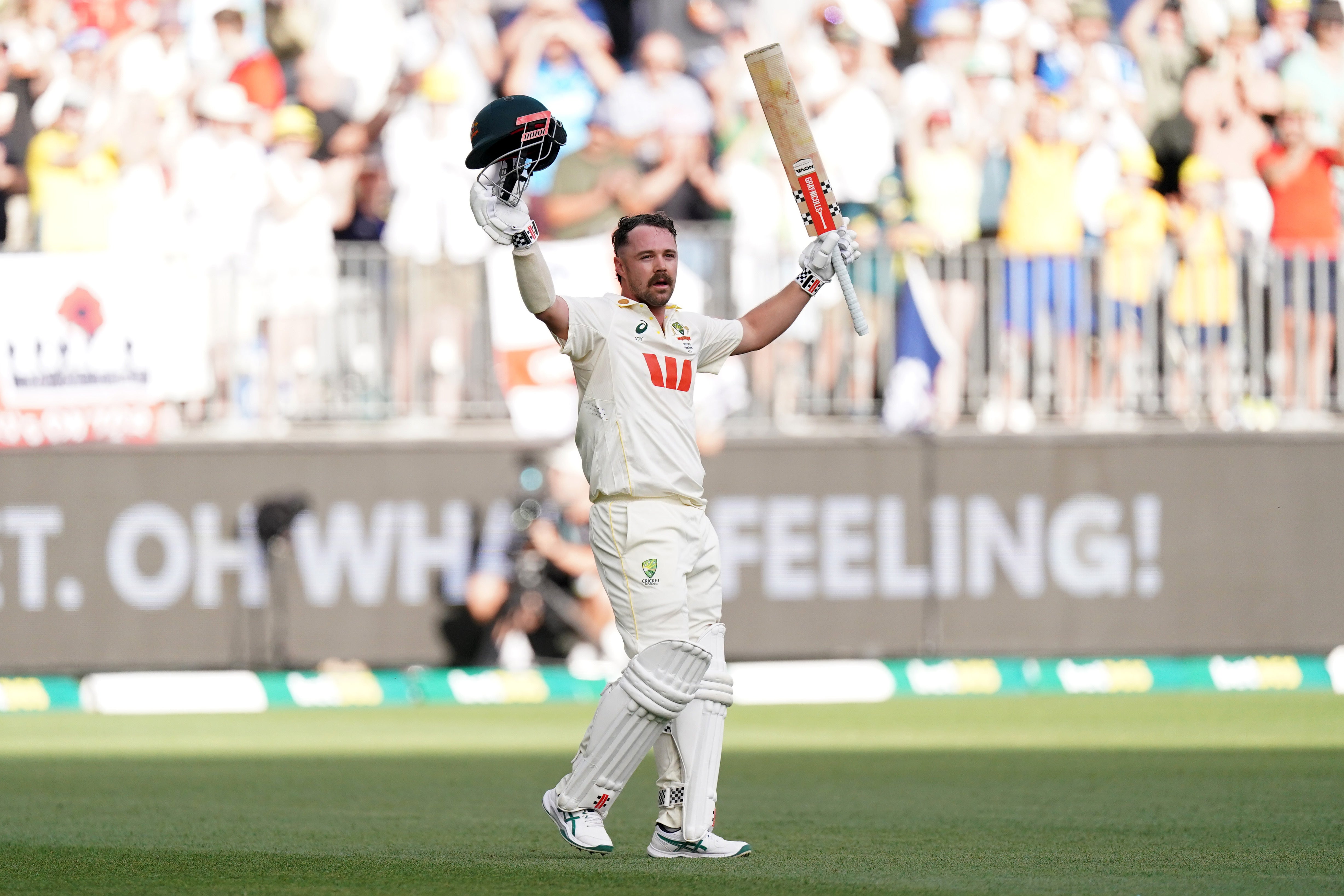<p>Travis Head raises his bat as he walks off the field after being dismissed (Robbie Stephenson/PA)</p>