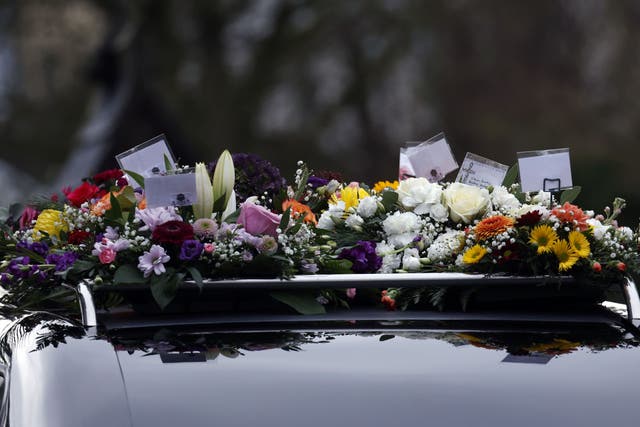 Tribute wreaths sit atop the hearse at Chloe McGee’s funeral (Conor O Mearain/PA)