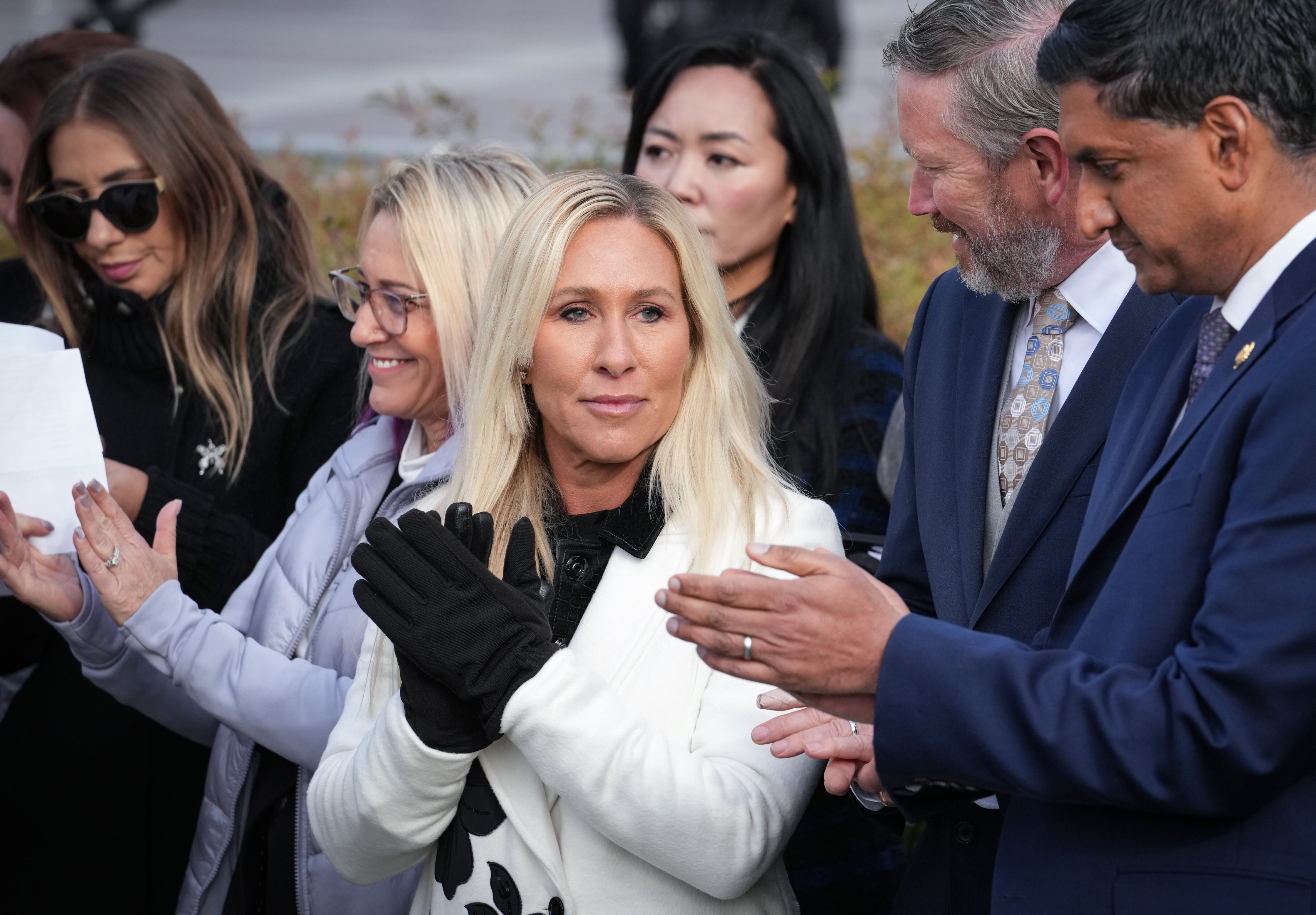 <p>Rep. Marjorie Taylor-Greene, R-Ga., center, will resign from Congress on January 5, 2026, she announced last week</p>