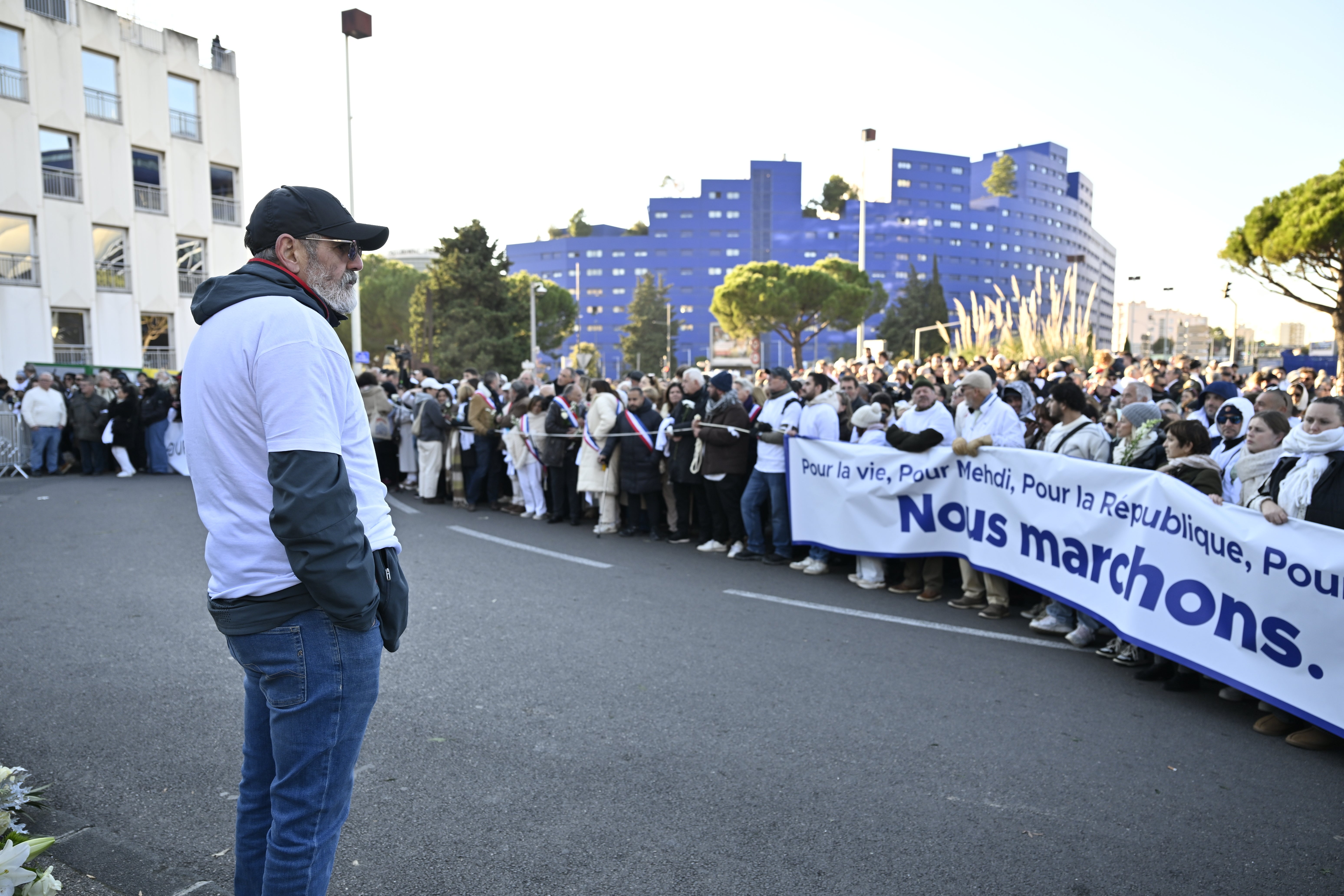 The father of Mehdi Kessaci attends the gathering homage to his son Mehdi at the roundabout where he was murdered, and to protest against drug trafficking in Marseille, southern France, Saturday, Nov. 22, 2025. (AP Photo/Philippe Magoni)