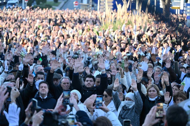 <p>Amine Kessaci, center, attends a gathering in homage to his brother Mehdi Kessaci at the roundabout where he was murdered, and to protest against drug trafficking, in Marseille, southern France, Saturday, Nov. 22, 2025. (AP Photo/Philippe Magoni)</p>