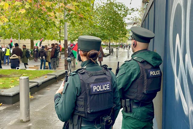 Officers from the PSNI observe a Defend Our Juries protest in support of Palestine Action in Belfast (David Young/PA)