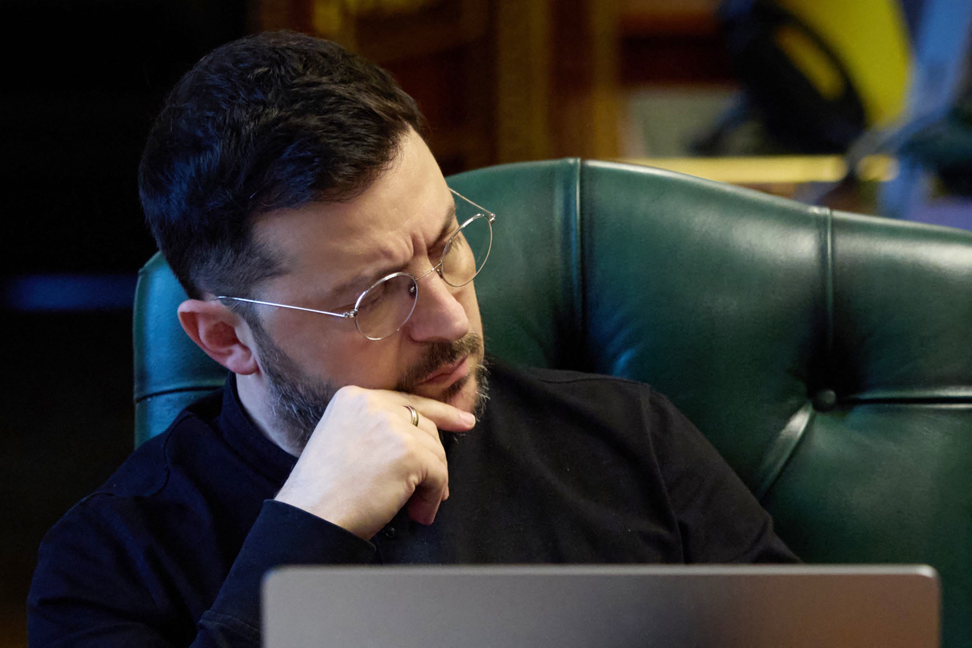 Ukraine's president Volodymyr Zelensky listening during a phone call with French president, British prime minister and German chancellor while sitting at his office in Kyiv