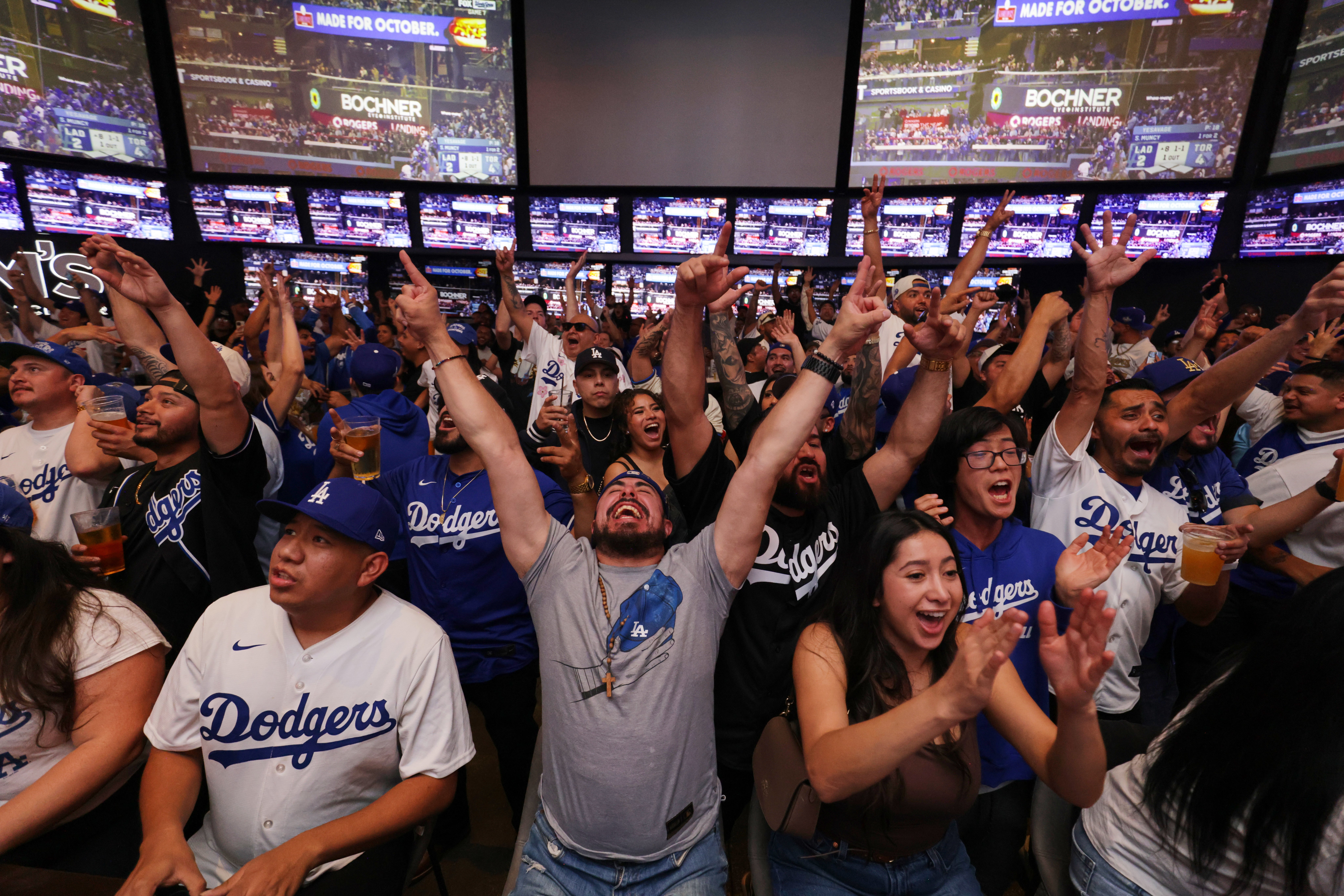 Fans react as the Los Angeles Dodgers play the Toronto Blue Jays in Game 7 of baseball's World Series at a watch party on Saturday, Nov. 1, 2025, in Los Angeles. (AP Photo/Ethan Swope, File)
