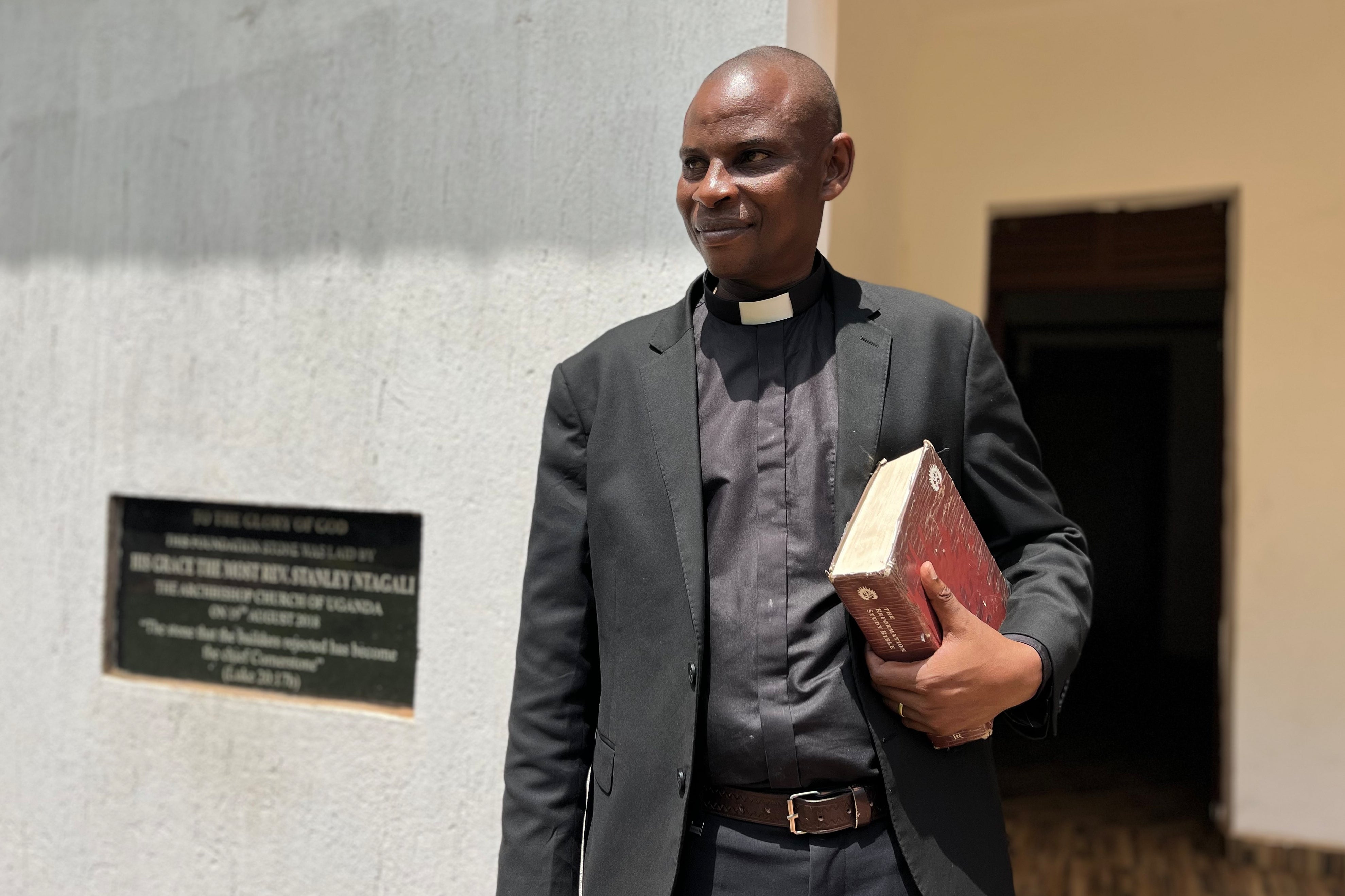The Rev. Robert Wantsala, vicar of a small Anglican parish in eastern Uganda, stands at the headquarters of the diocese in Mbale, Uganda