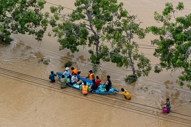 <p>This aerial photo shows people wading through floodwaters in Phan Rang in southern Vietnam's Khanh Hoa province on 21 November 2025</p>