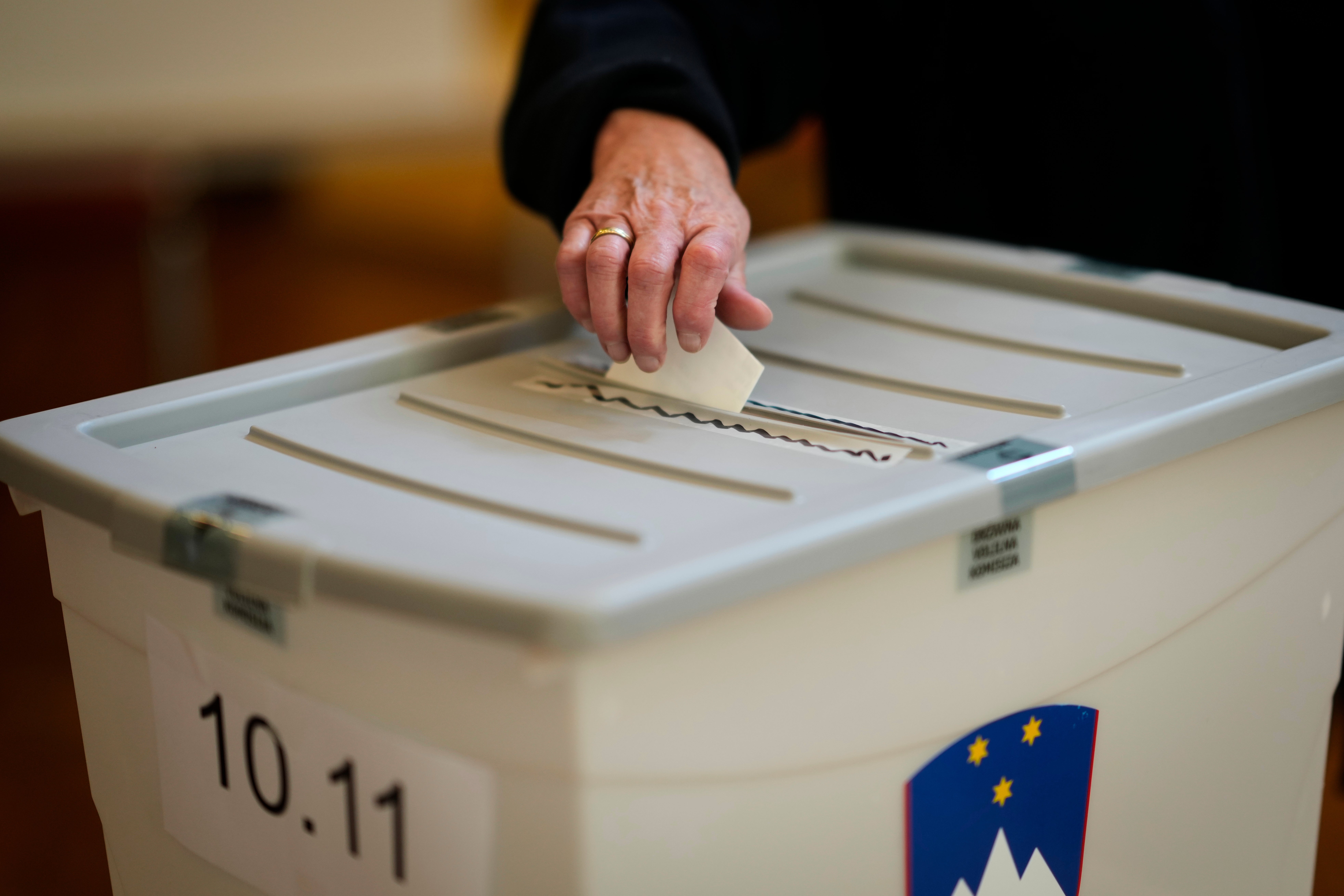 A voter casts her ballot at a polling station during the referendum on assisted dying for terminally ill patients, in Domzale, Slovenia, Sunday, Nov. 23, 2025. (AP Photo/Darko Bandic)