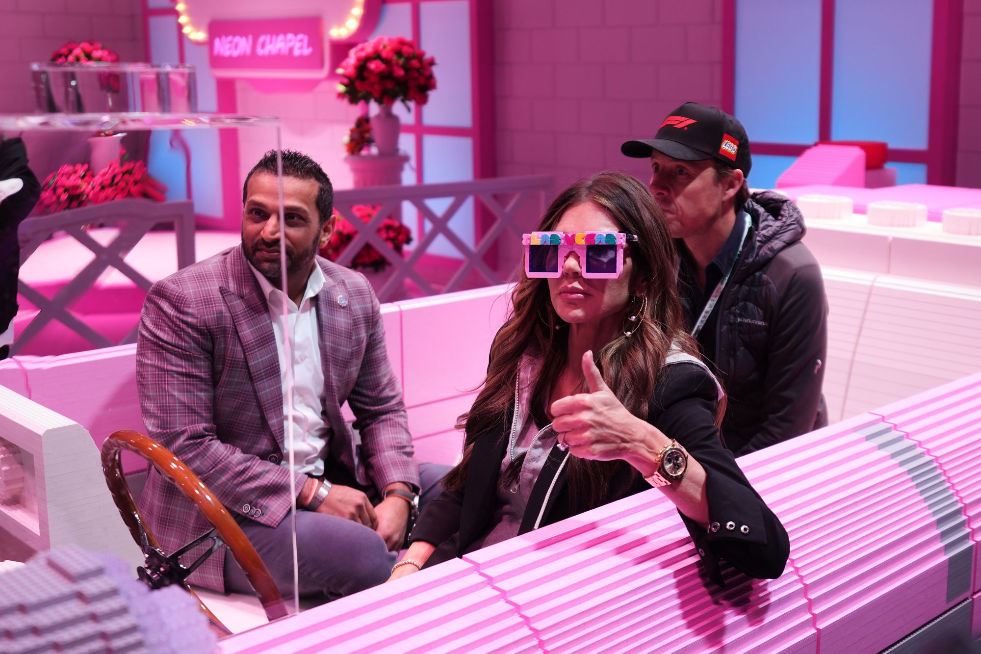 FBI director Kash Patel and U.S. Secretary of Homeland Security Kristi Noem sit in a pink Cadillac made of LEGO blocks in Las Vegas ahead of the Grand Prix this weekend. Their trip comes as Patel faces criticism over his use of taxpayer-funded resources