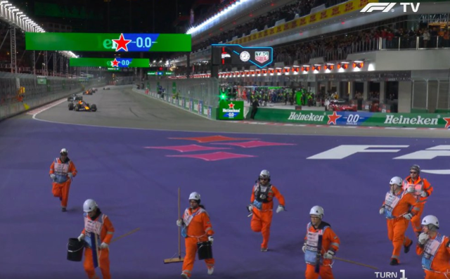 <p>Marshals run off track at the start of the Las Vegas GP with Max Verstappen storming round</p>