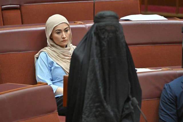 <p>Independent senator Fatima Payman reacts as One Nation leader Pauline Hanson wears a burqa in the Senate chamber at Parliament House in Canberra, Australia, November 24, 2025. </p>