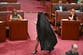 Australian far-right senator accused of ‘blatant racism’ after wearing burqa to parliament
