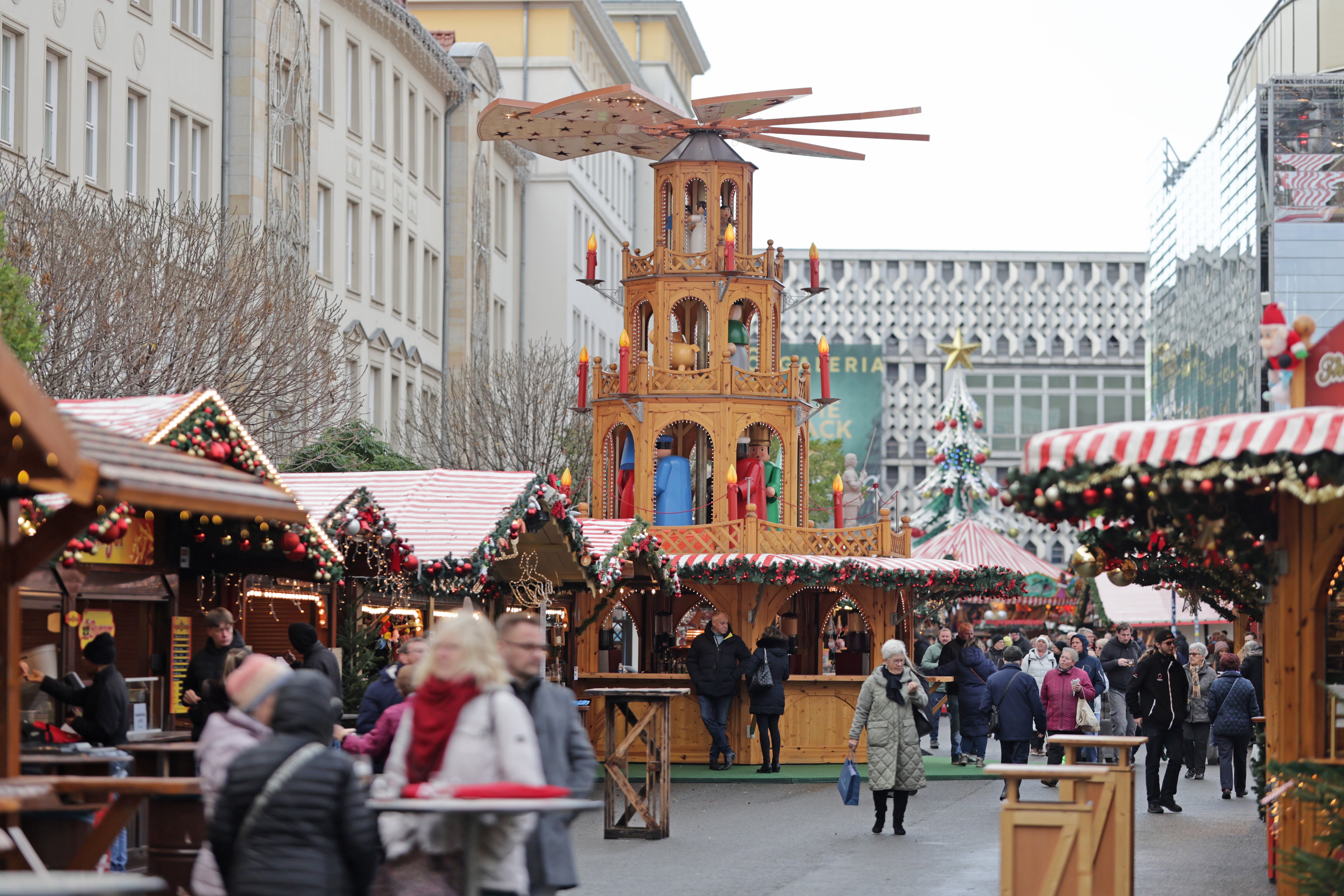 <p>Visitors walk through the Magdeburg Christmas market, in Magdeburg, Germany</p>