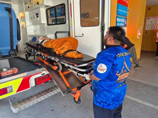 <p>Emergency rescue teams transport the woman found to still be alive </p>