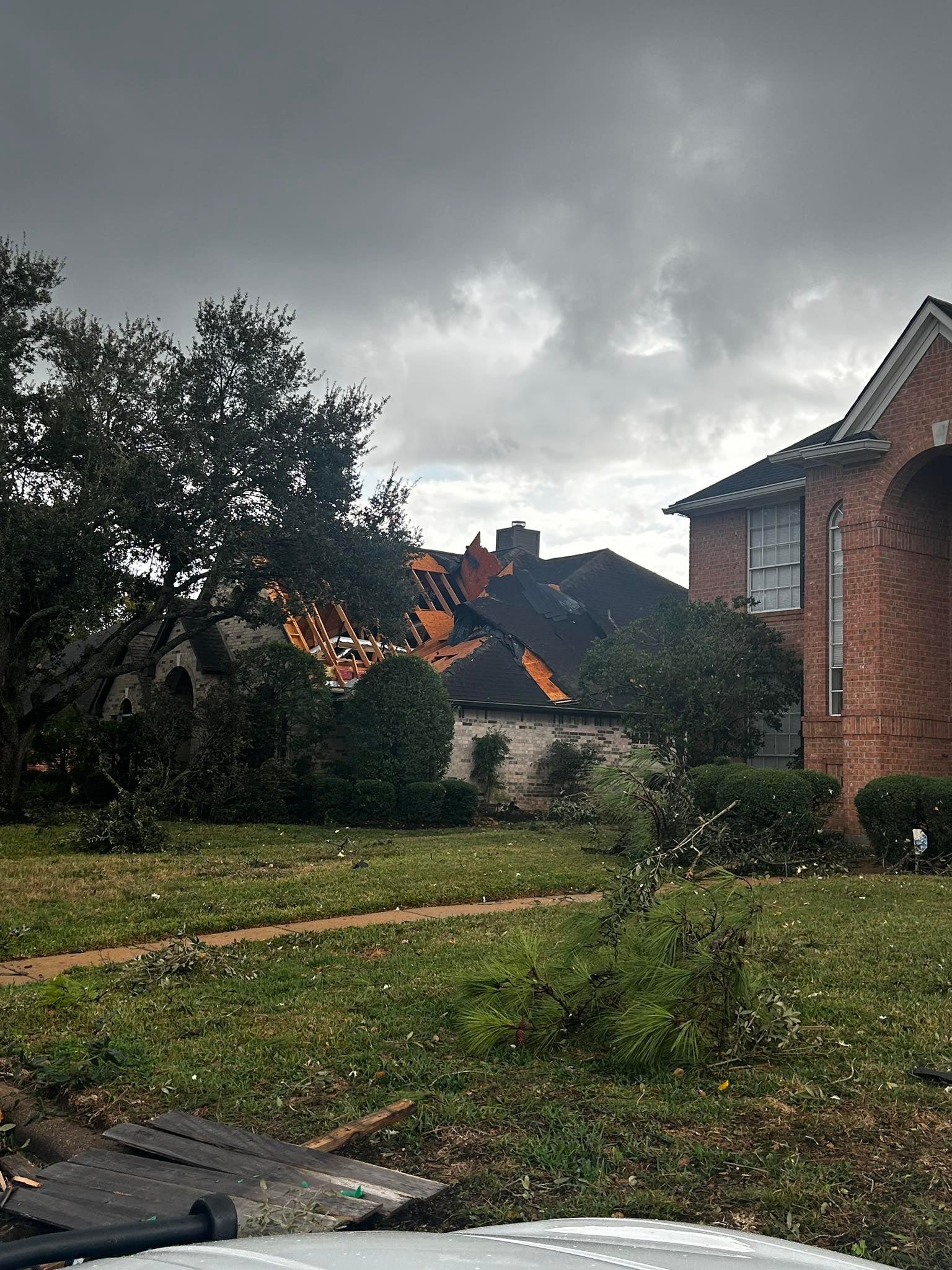 A house is seen with its roof torn off in northern Harris County, Texas, on Monday