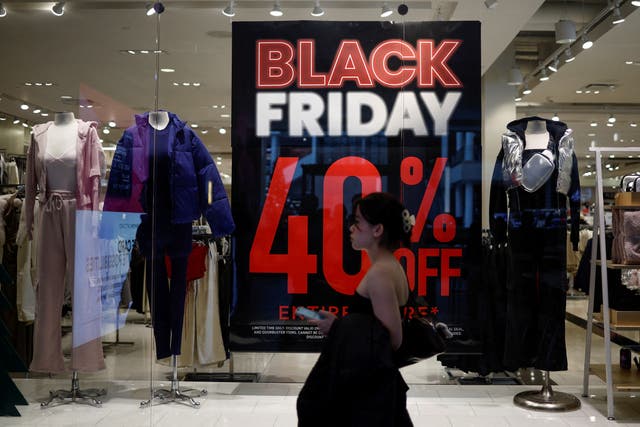 <p>A shopper walks past an advertisement for Black Friday sales displayed in a store window at Pentagon City in Arlington, Virginia, U.S., November 27, 2024.</p>