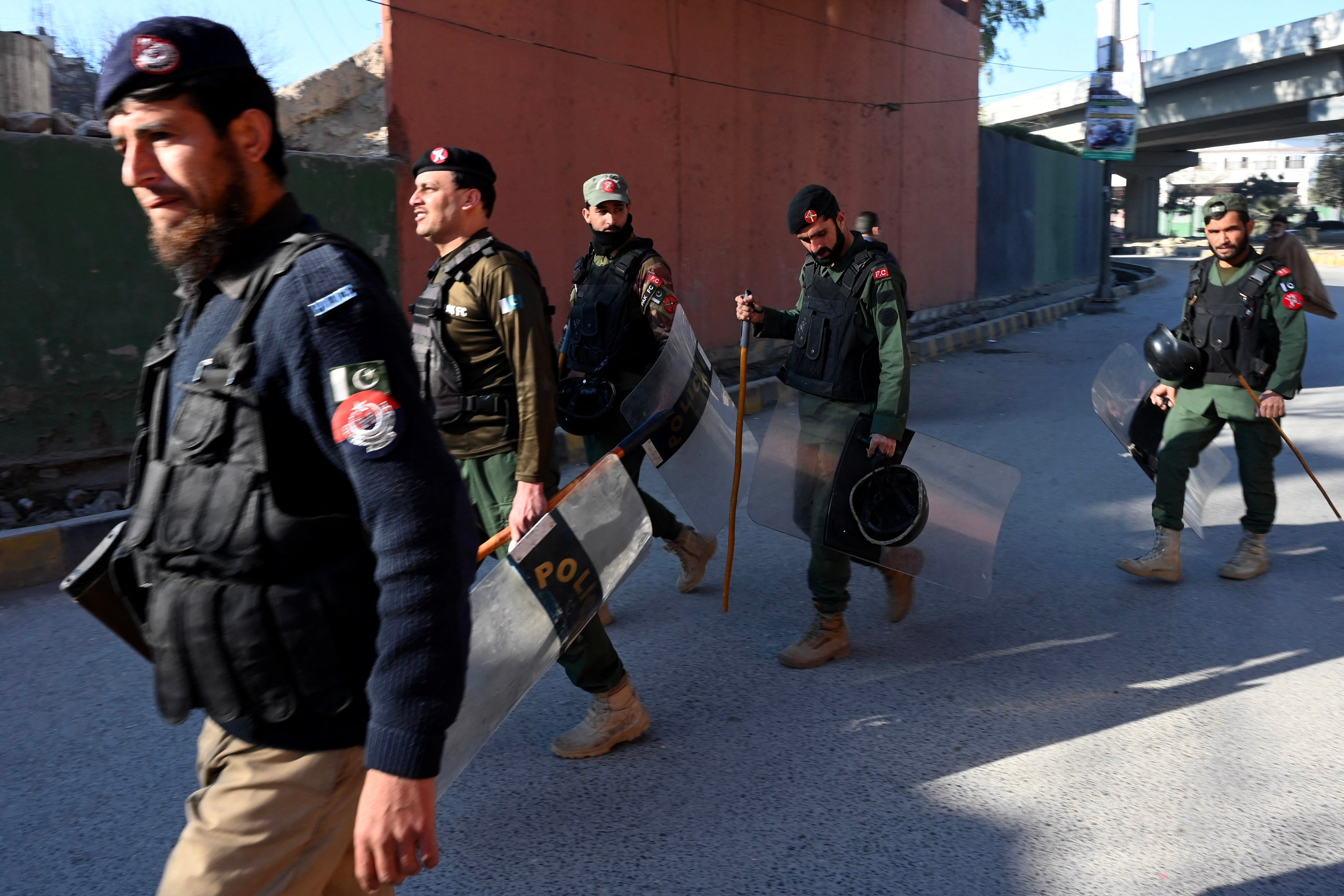 File: Police patrol along the street in Peshawar