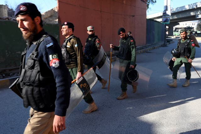 <p>File: Police patrol along the street in Peshawar</p>