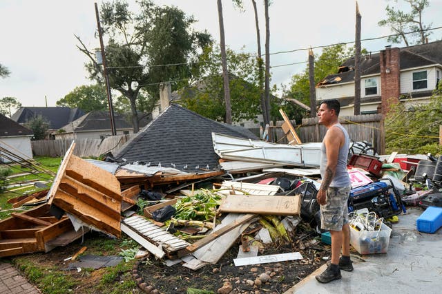 <p>Jose Rosas surveys damage to Guillermo Vargas' home as while helping clean up storm damage in the Memorial Northwest subdivision, in Spring, Texas, Monday, Nov. 24, 2025</p>