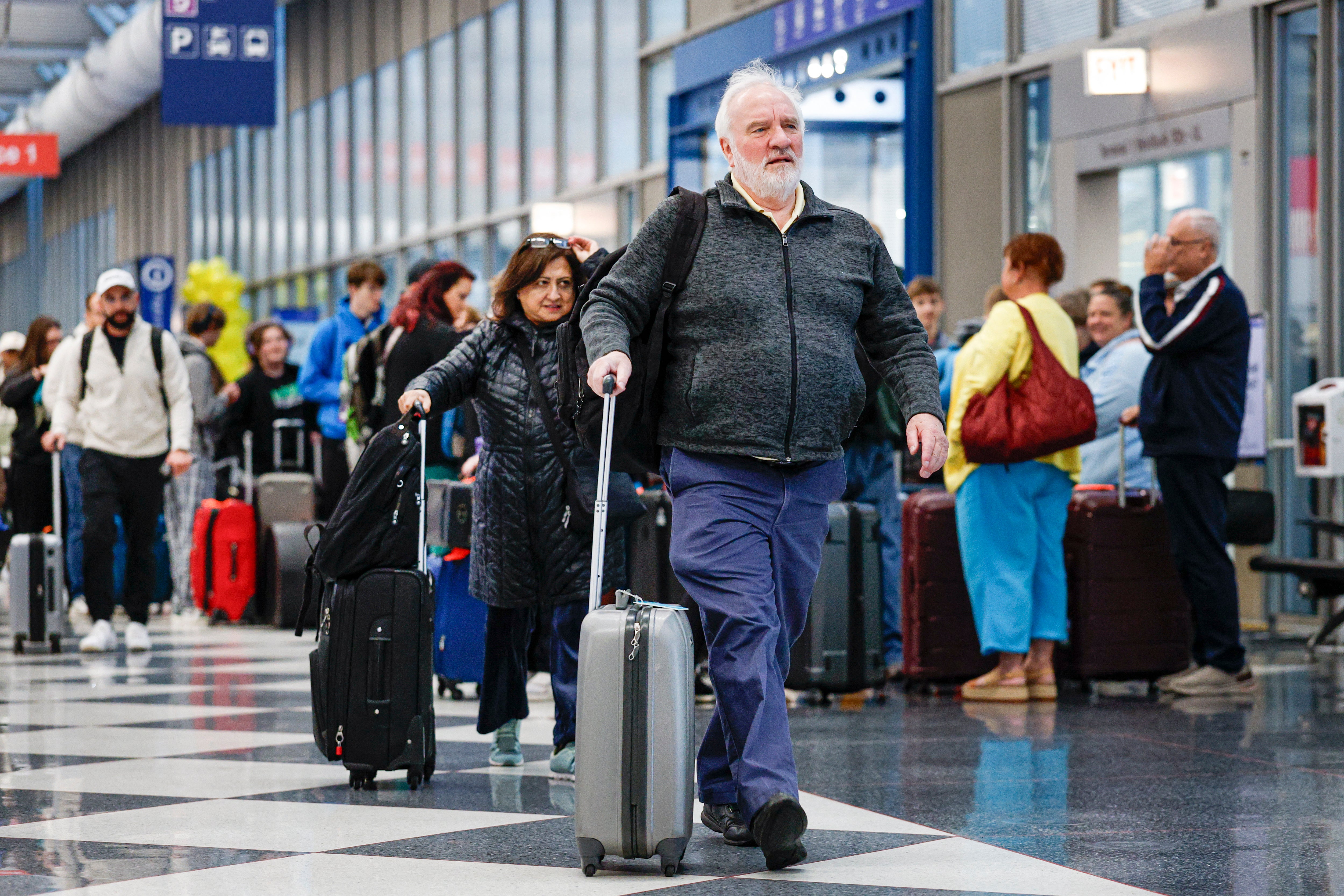 Travelers arrive for flights at O'Hare International Airport in Chicago, Illinois, on November 25, 2025