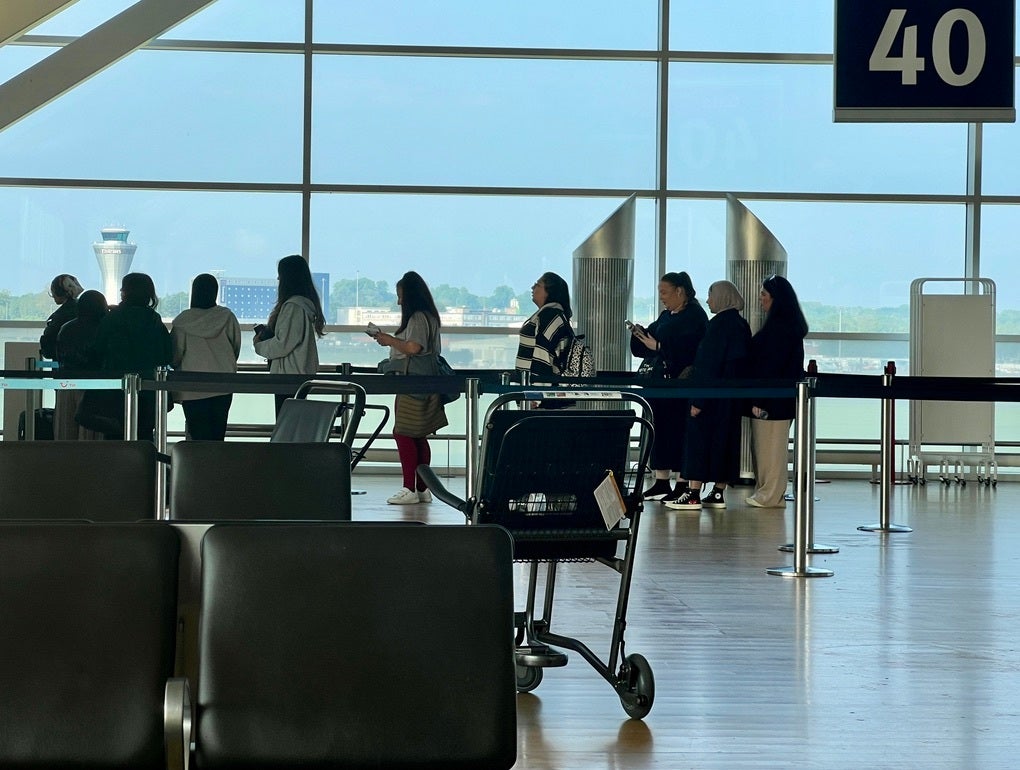 <p>Passengers queue at Birmingham airport</p>