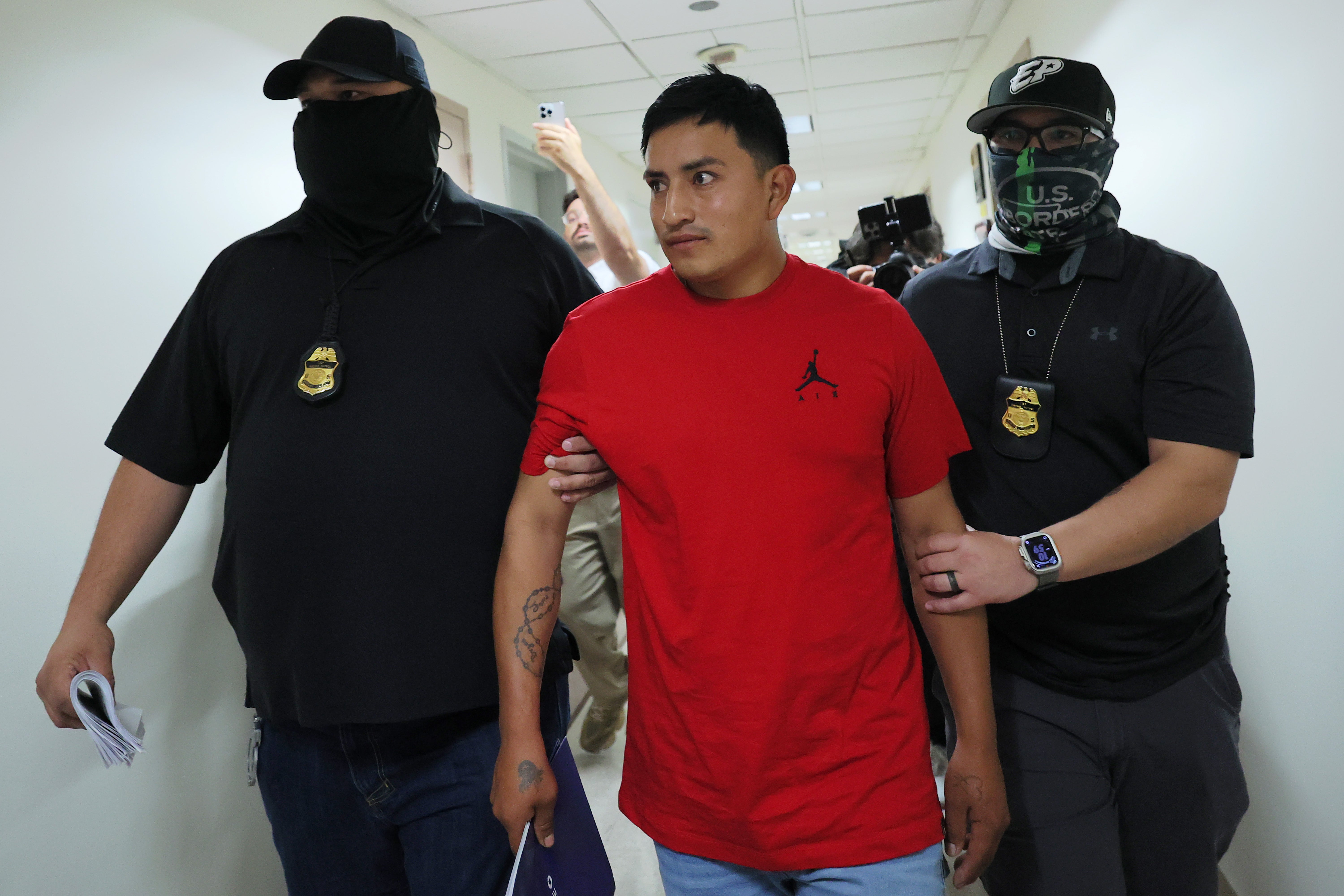 Federal agents detain a man after exiting a court hearing in immigration court at the Jacob K. Javitz Federal Building on September 12 in New York City.