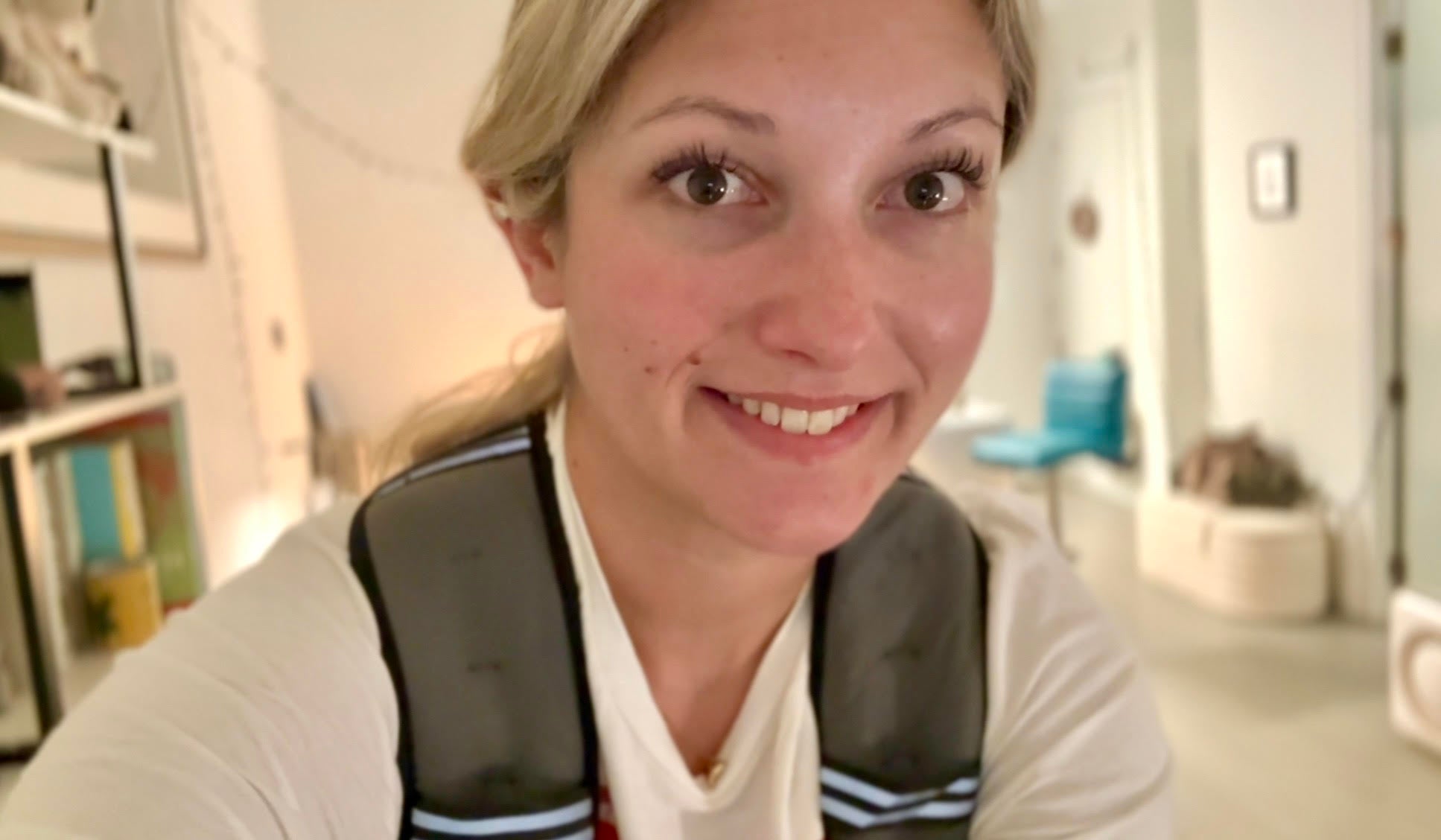 Musto rides her Peloton bike in her New York City apartment wearing a weighted vest