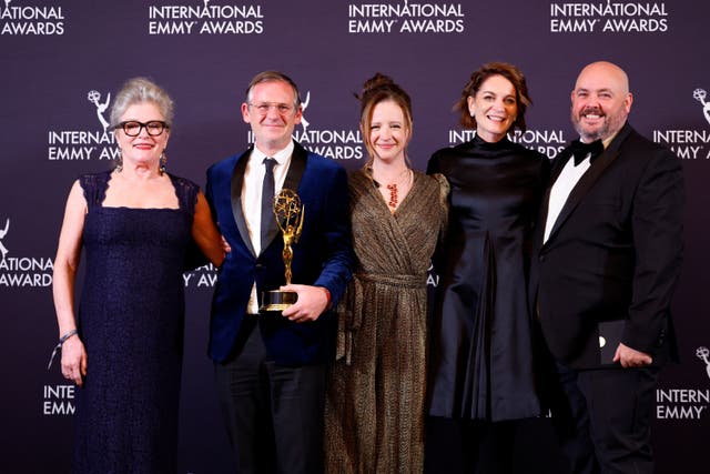 <p>Dominic Treadwell-Collins and team pose with the Best Drama Series Award for 'Rivals' during the 2025 International Emmy Awards</p>
