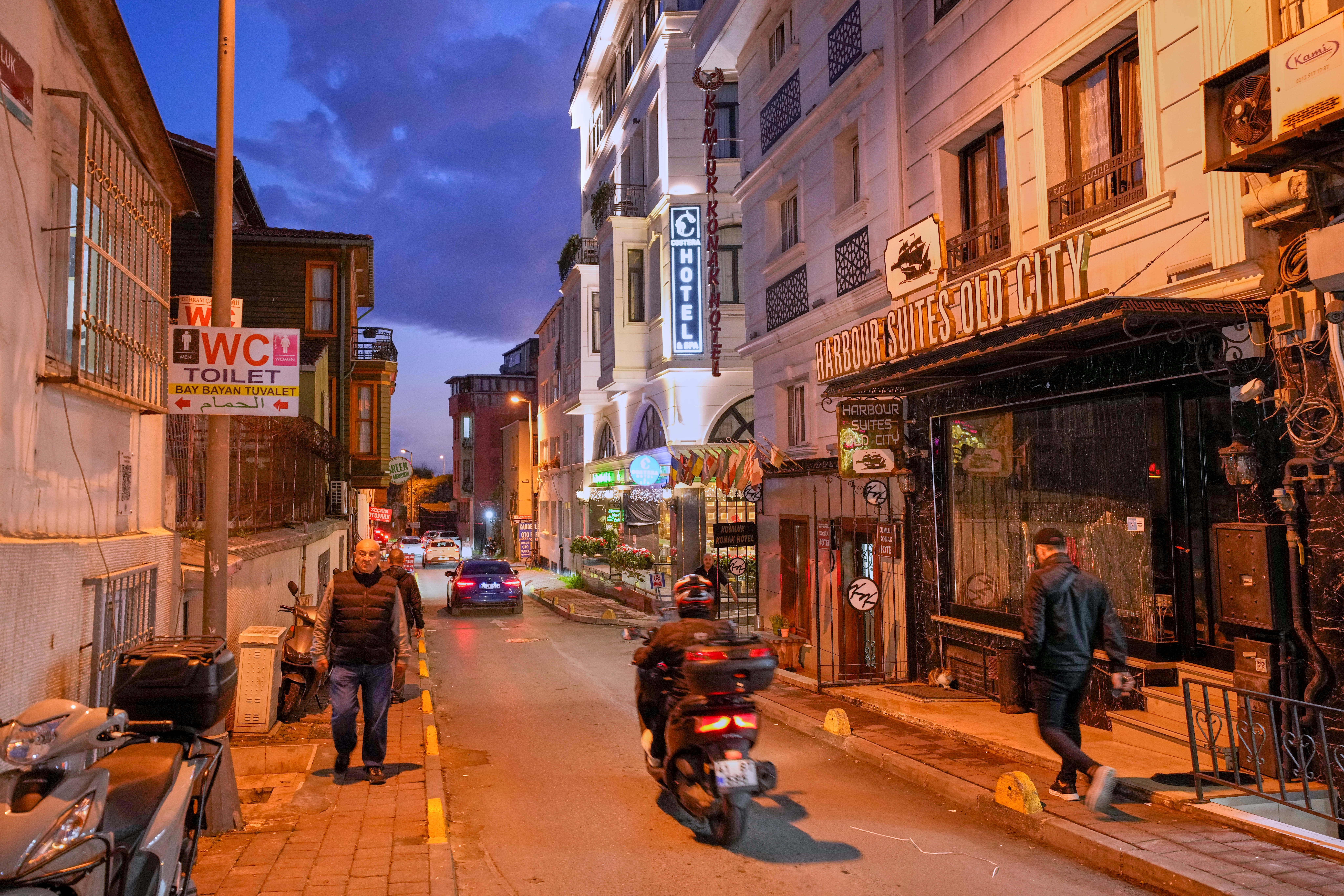 People walk past the Harbour Suites Old City hotel, in Istanbul, Turkey, Monday, Nov. 24, 2025. (AP Photo/Emrah Gurel)