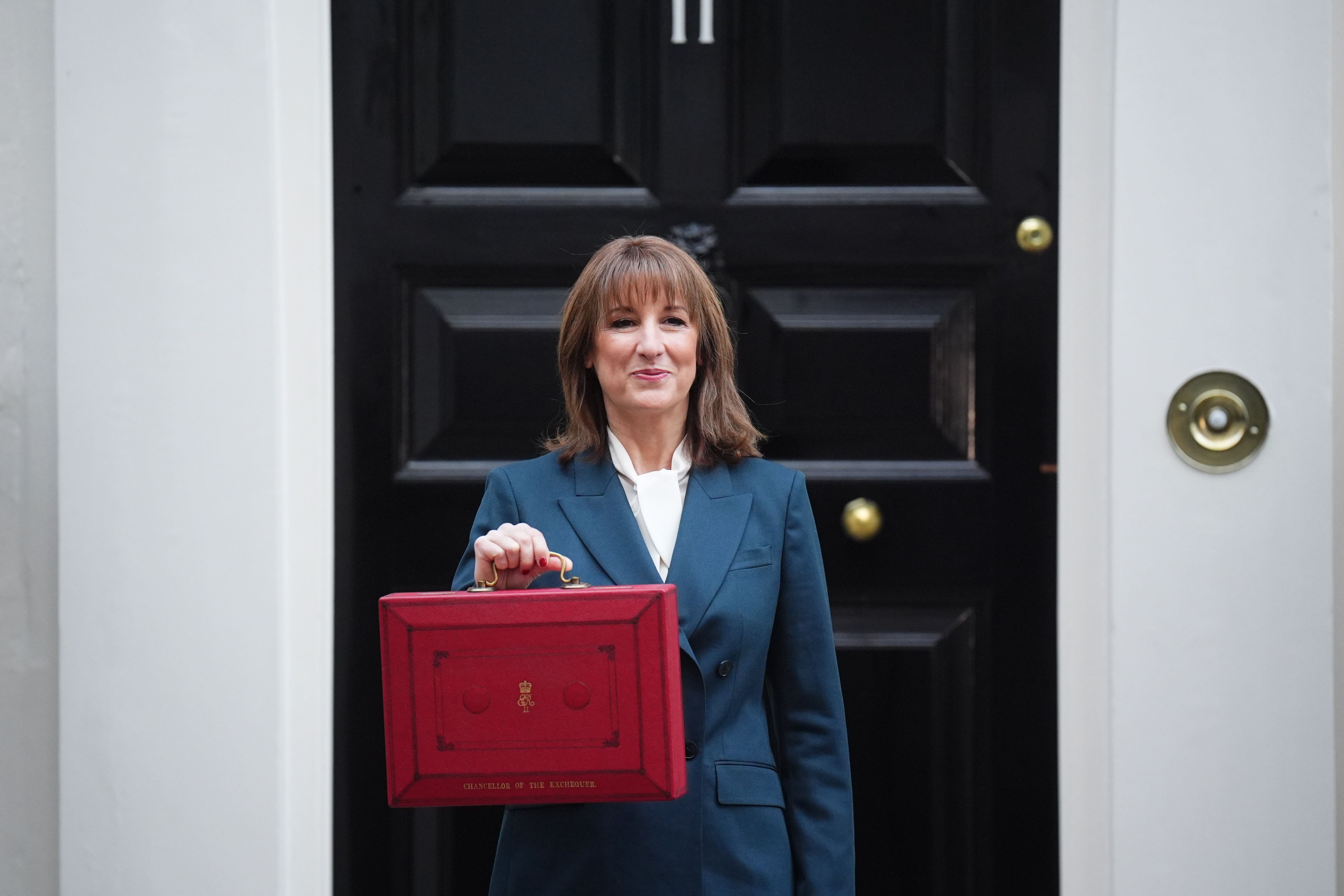 Chancellor Rachel Reeves poses outside 11 Downing Street, London, with her ministerial red box, before delivering her Budget in the House of Commons (James Manning/PA)
