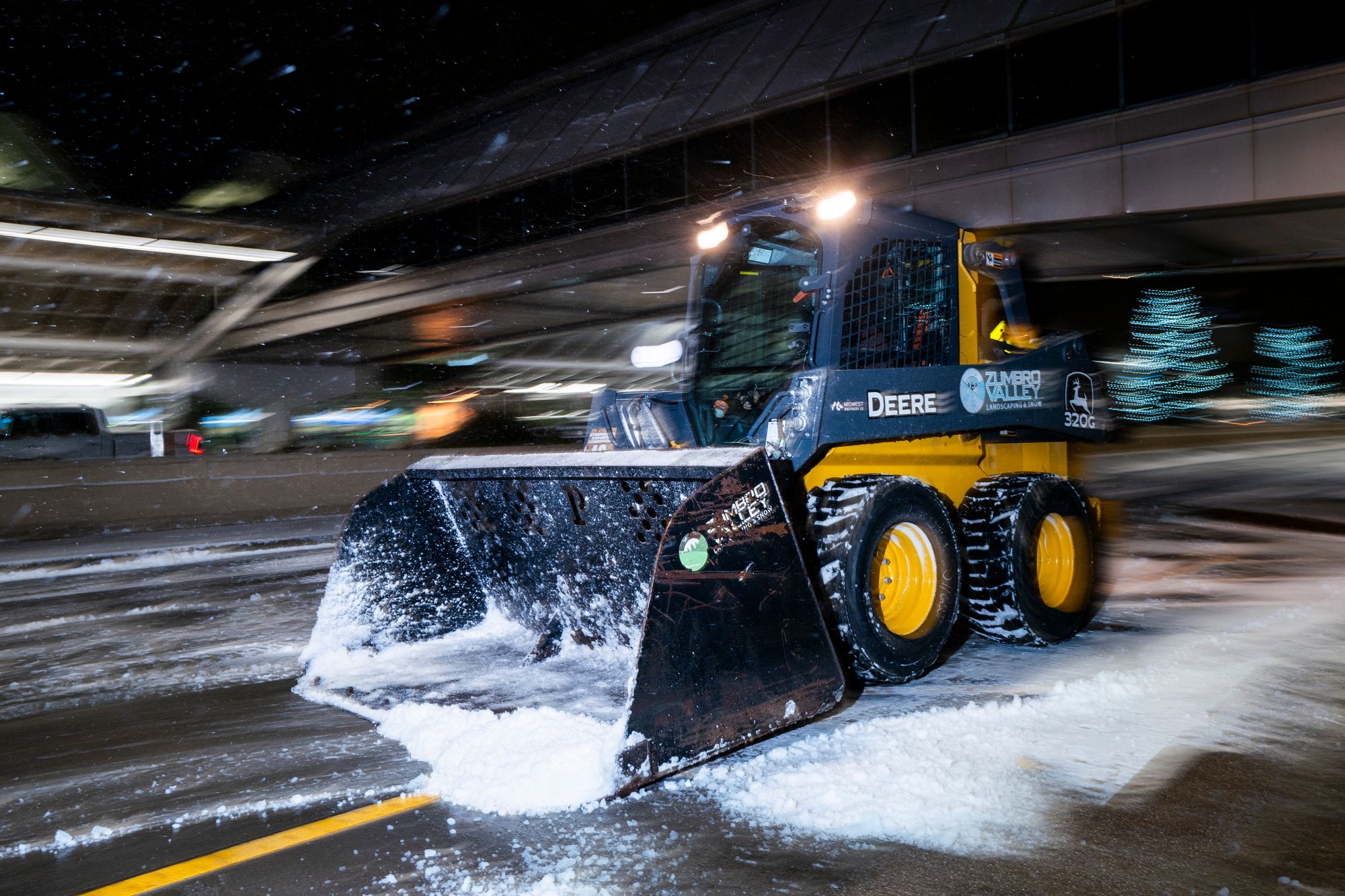 A plow removes snow outside Minneapolis-Saint Paul International Airport on Wednesday. Snow is dumping across the Midwest and Great Lakes regions.