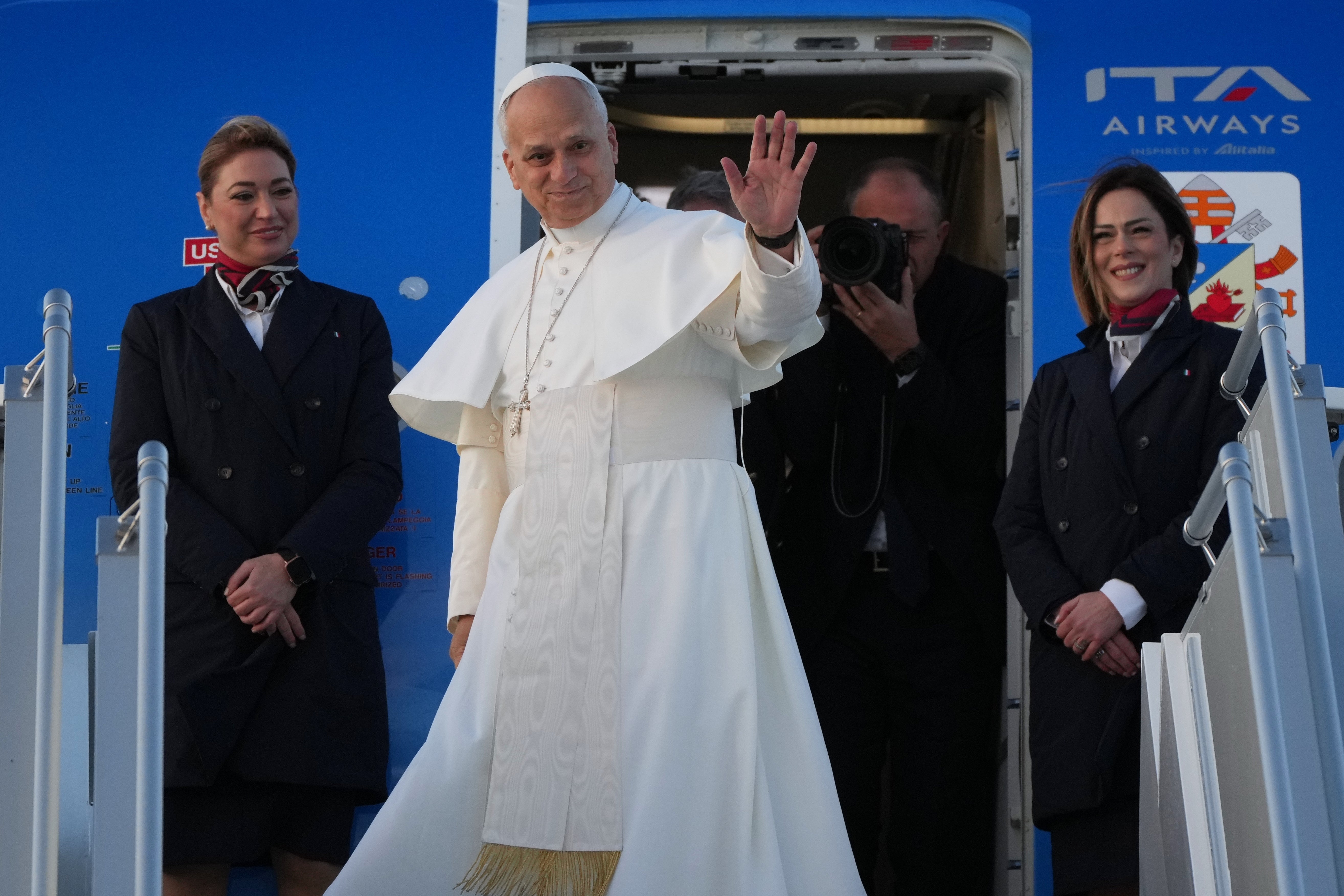 Pope Leo XIV waves as he boards a plane in Rome's Fiumicino airport on his way to a six-day trip to Turkey and Lebanon