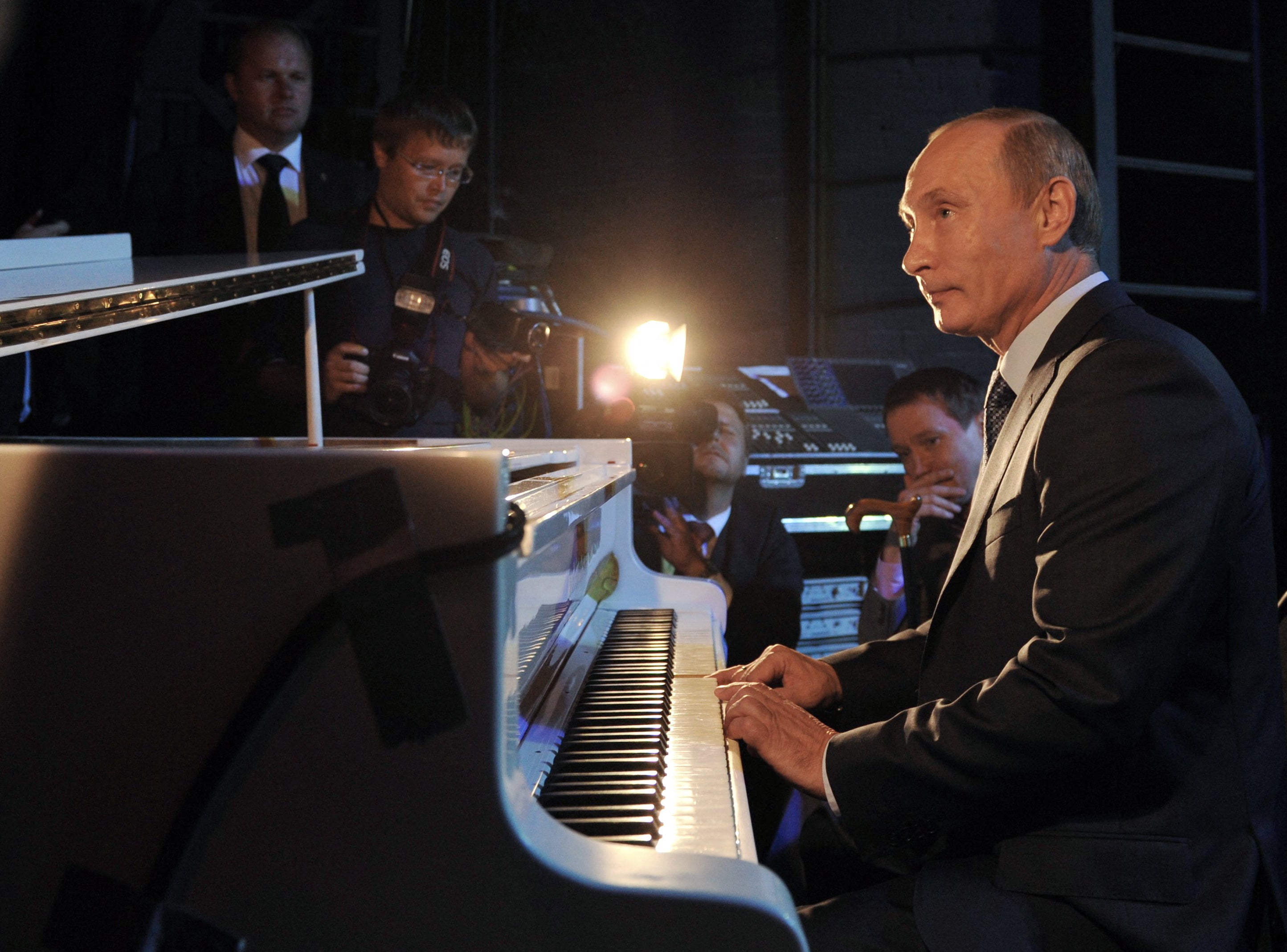 Another picture shows Putin playing the piano
