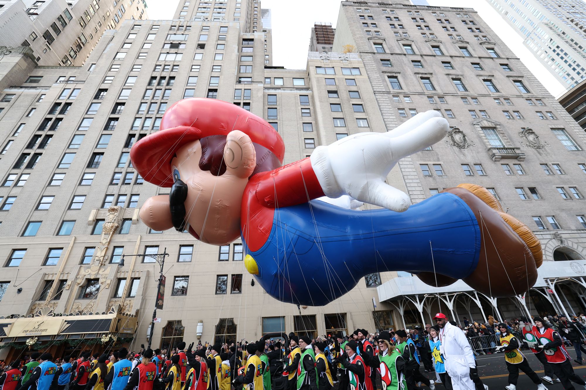 The Mario balloon floats down the street during the 2025 Macy's Thanksgiving Day Parade