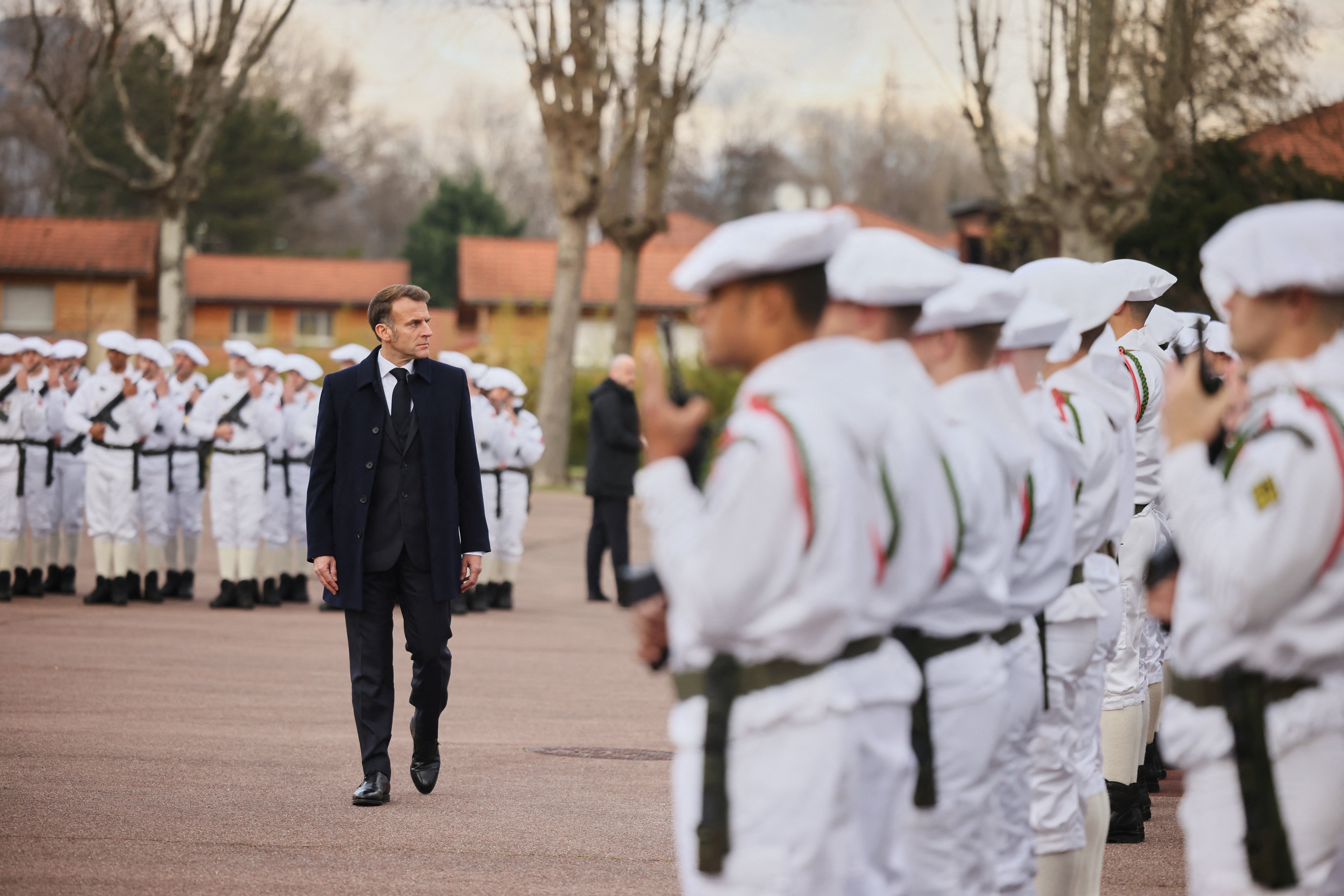 Macron reviews the troops before his speech to unveil a new national military service.