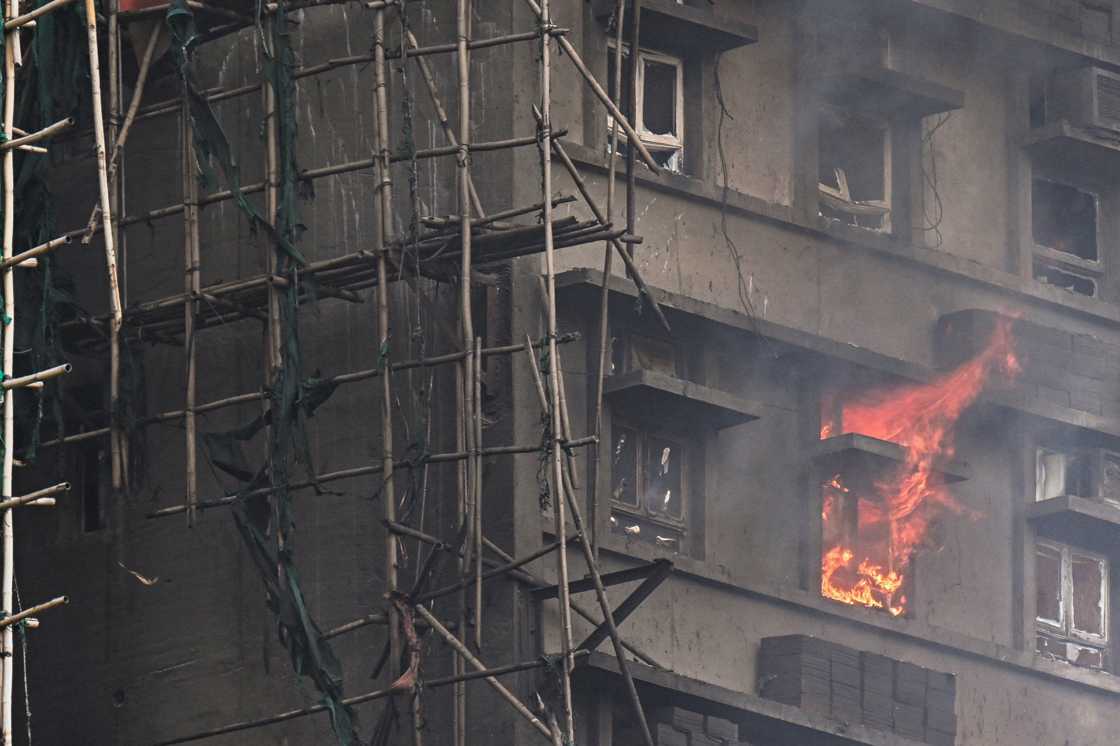 An apartment still burns as a major fire swept through several apartment blocks at the Wang Fuk Court residential estate in Hong Kong's Tai Po district