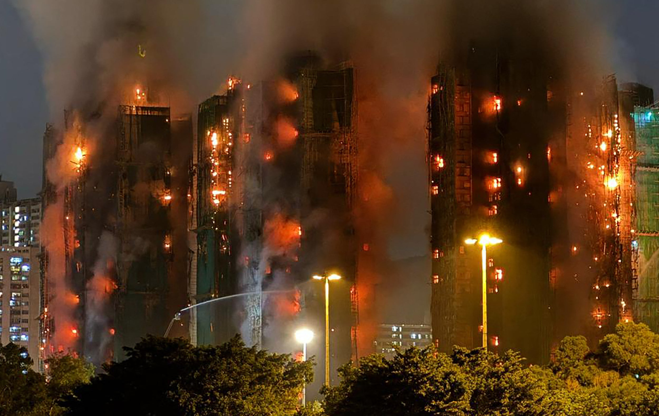 Thick smoke and flames rise as a fire engulfs several apartment blocks at the Wang Fuk Court residential estate in Hong Kong's Tai Po district on 26 November 2025