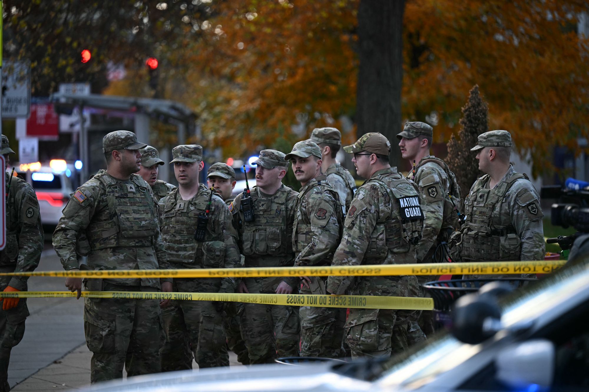 <p>National Guard soldiers stand behind the crime scene tape at a corner in downtown Washington, DC, on November 26, 2025</p>