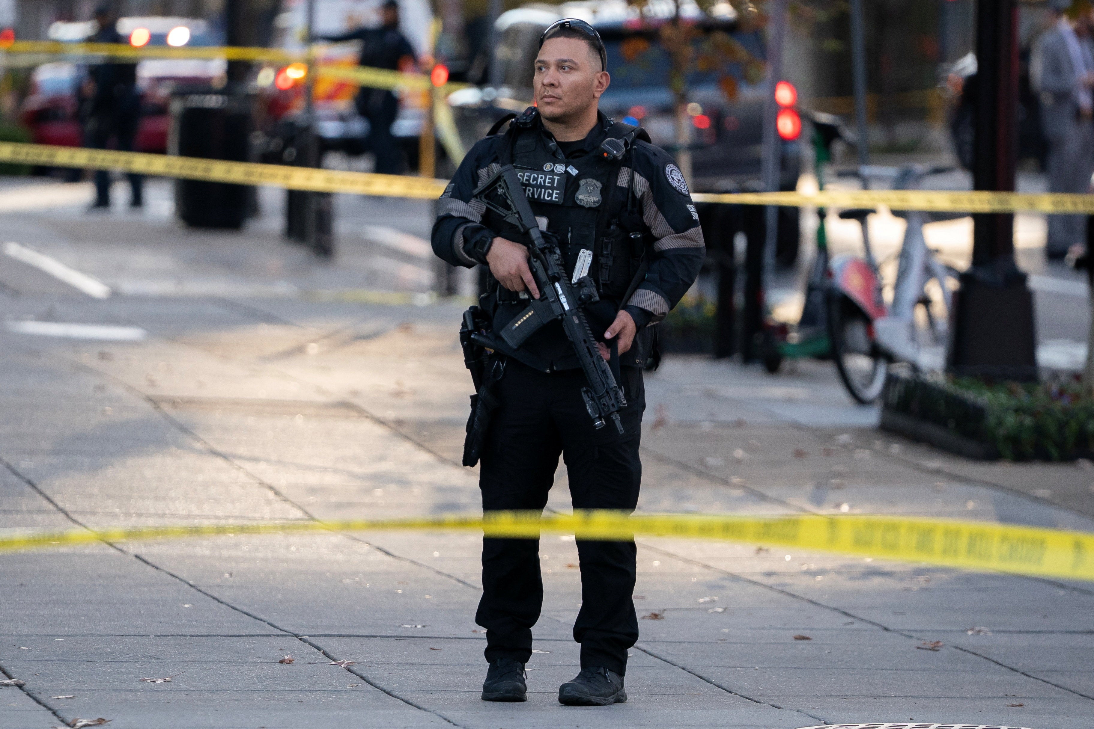 A member of the U.S. Secret Service stands guard in a cordoned-off area after two National Guard members were shot near the White House
