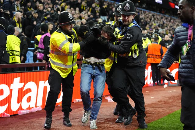 A Young Boys fan is escorted from the stadium by police during the UEFA Europa League, league phase match at Villa Park, Birmingham (Nick Potts/PA)