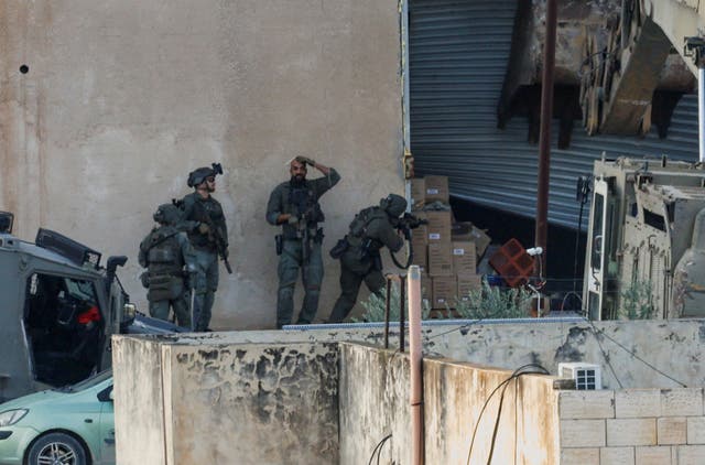 <p>Israeli soldiers take position during a raid in Jenin in the Israeli-occupied West Bank</p>
