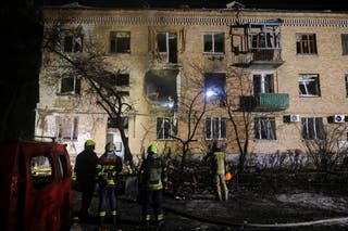 Emergency responders work at the site of an apartment building that was hit during a Russian missile and drone attack on Kyiv, amid Russia's attack on Ukraine