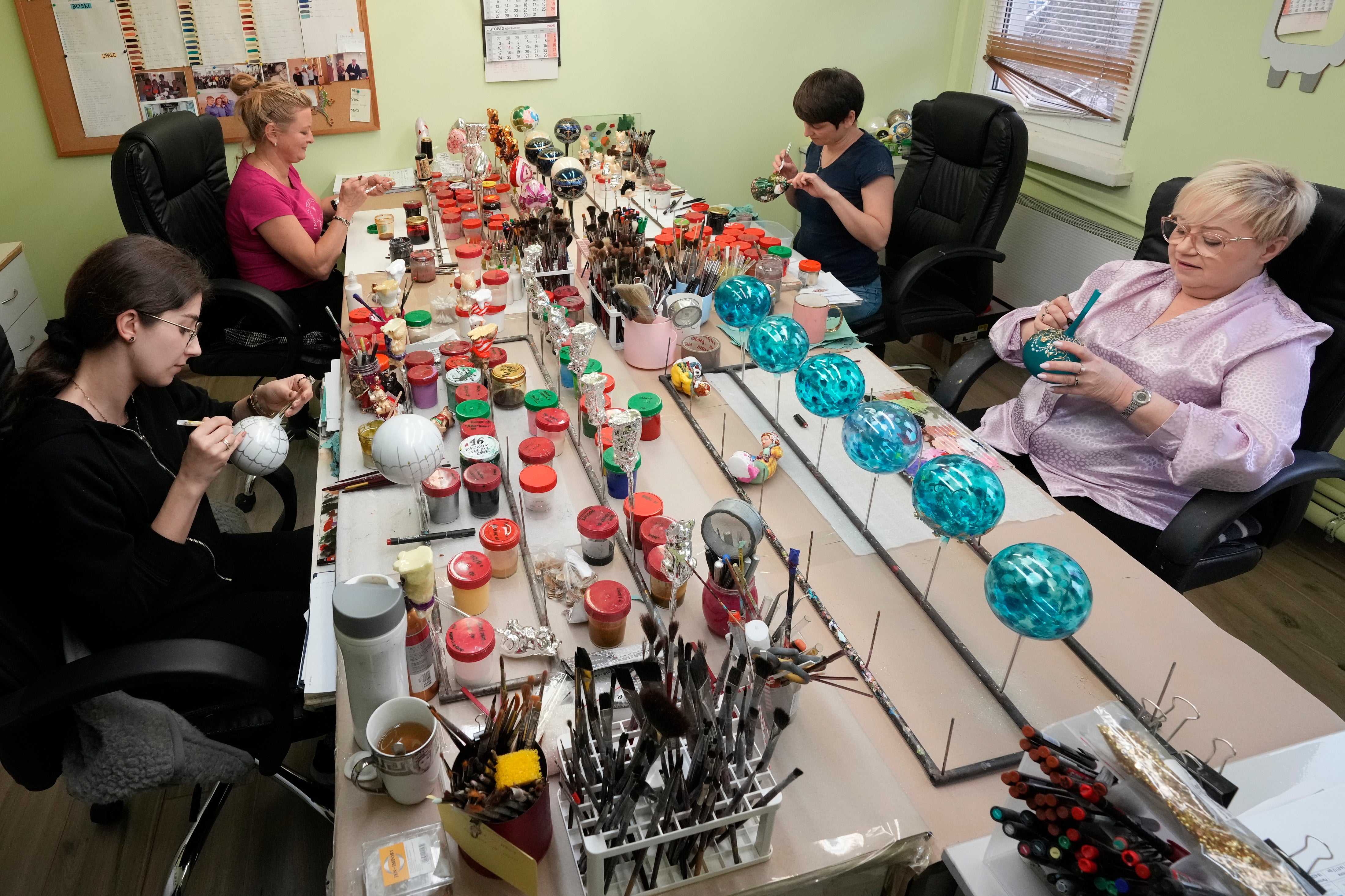 Workers prepare the hand-made Christmas baubles at GlitterLab
