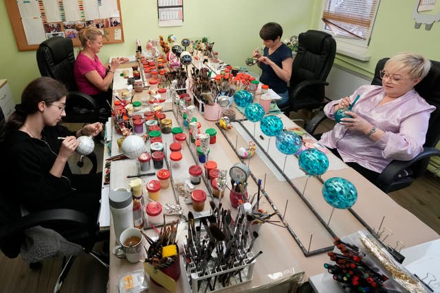 <p>Workers prepare the hand-made Christmas baubles at GlitterLab</p>
