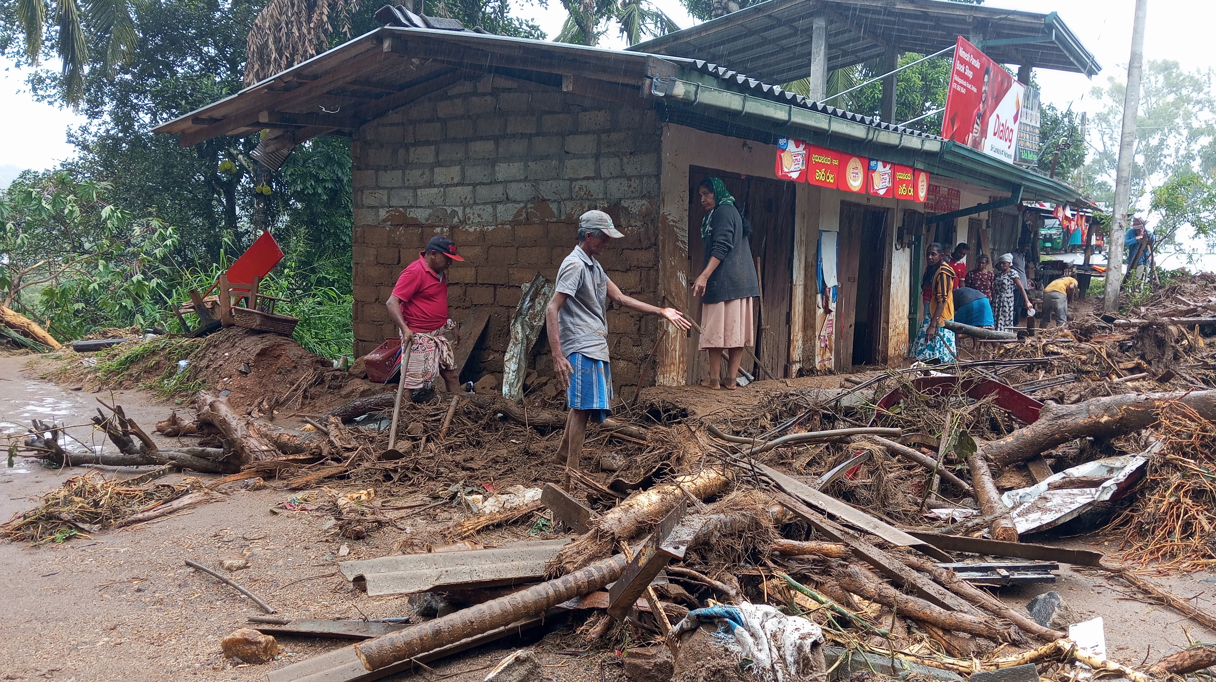 Landslide survivors clean the debris in Hanguranketha, Sri Lanka, Saturday