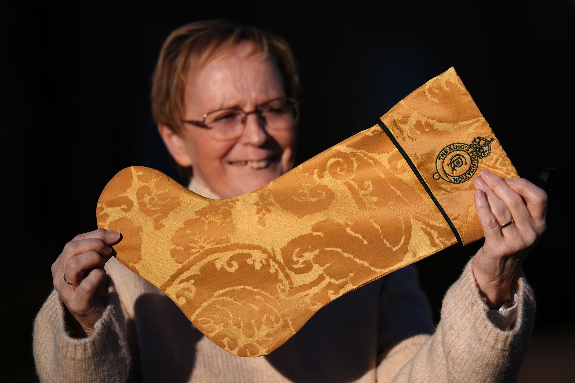 Andrea Middlemiss holds up a Christmas stocking