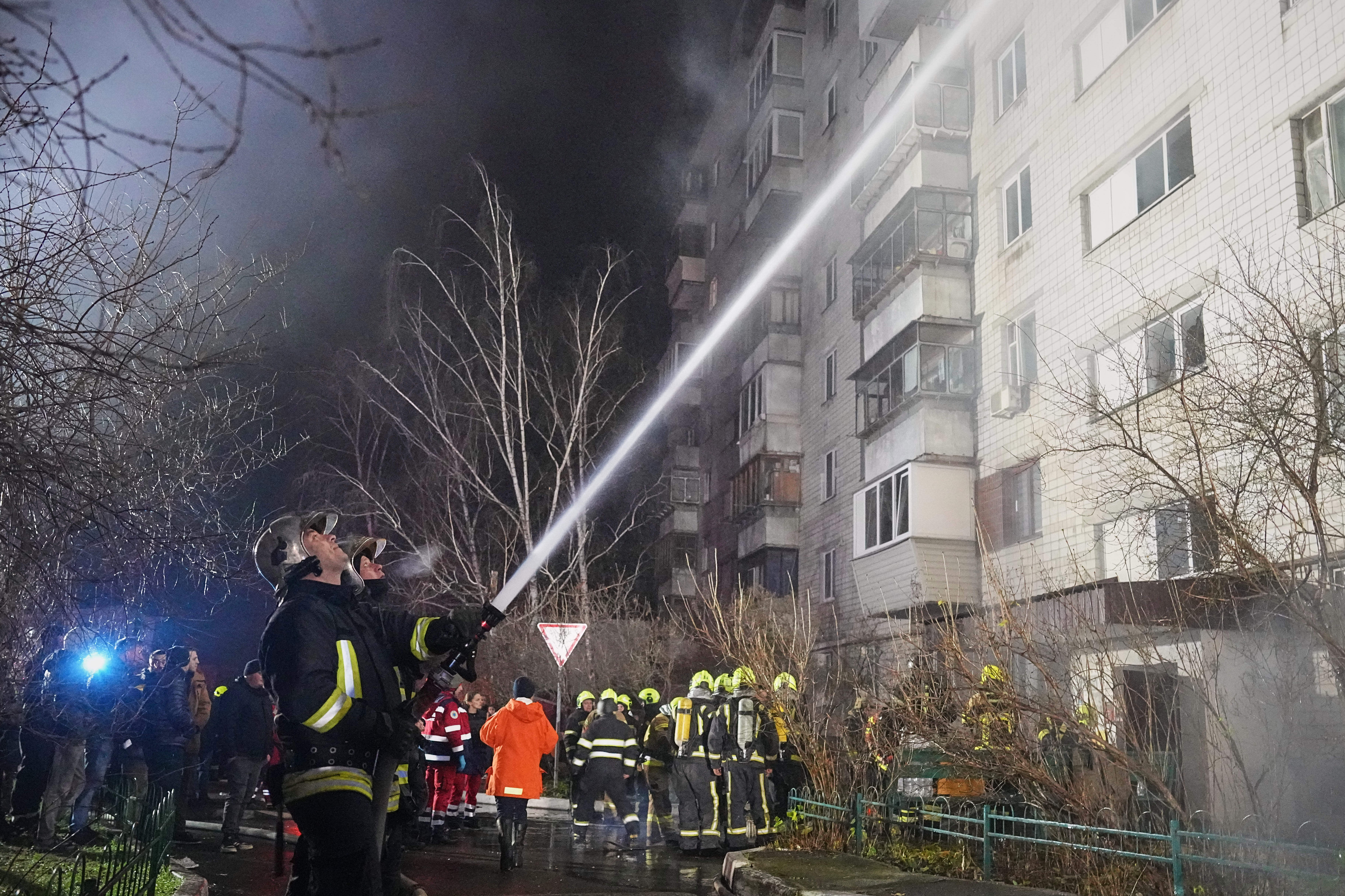 Firefighters put out a blaze after a Russian attack in Vyshgorod, outside of Kyiv, Ukraine
