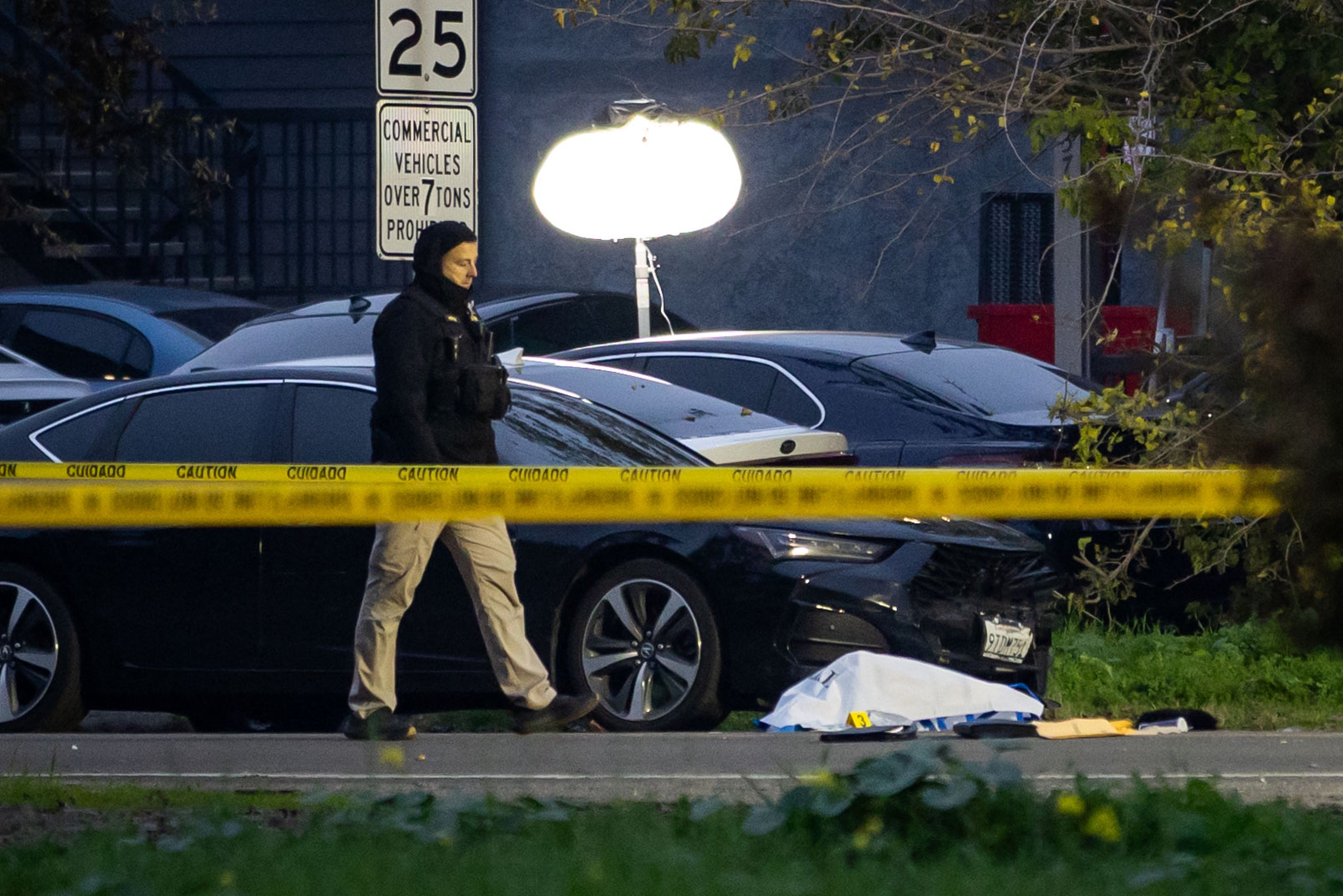 <p>Investigators at the scene of the shooting</p>