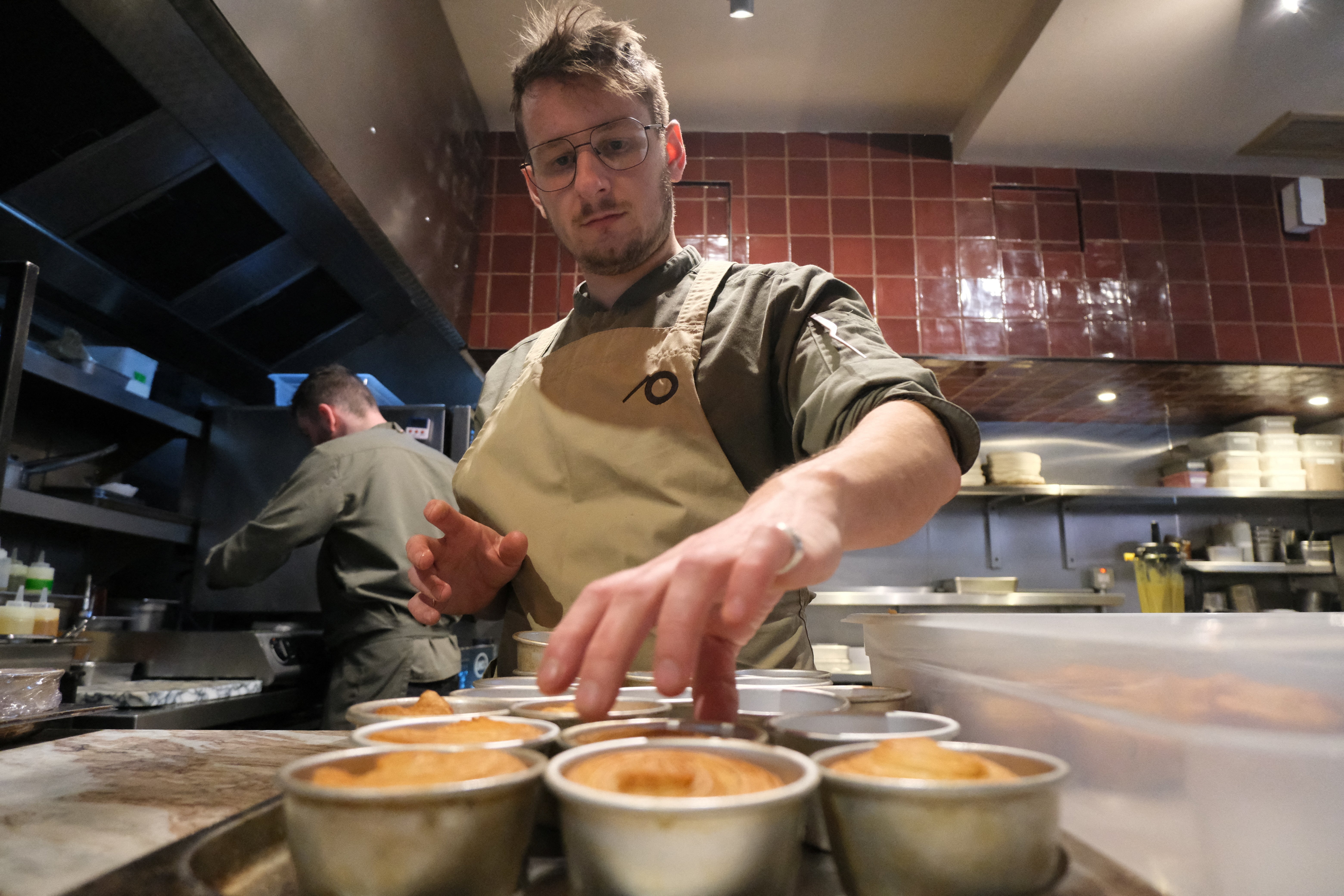 A chef prepares a vegan dish at Plates restaurant in London, Britain, November 21, 2025. REUTERS/Sam Tabahriti