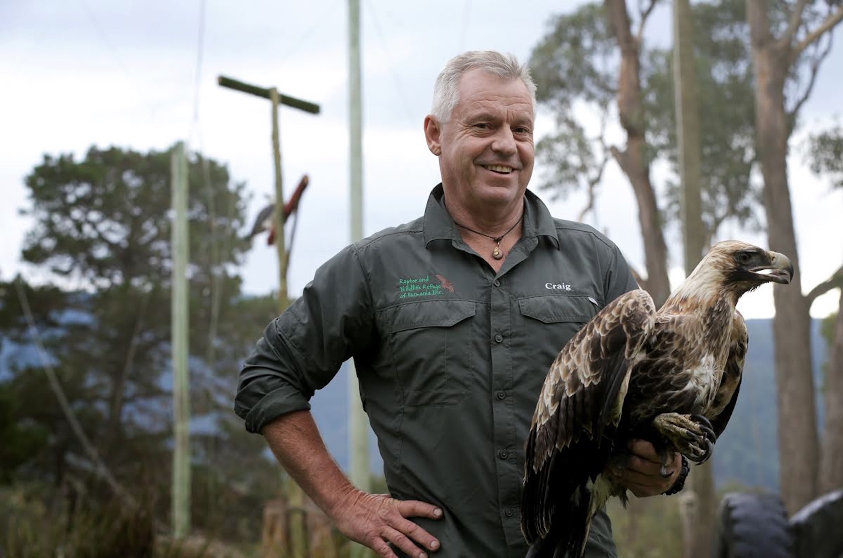 Craig Webb holding a bird at the Raptor and Wildlife Refuge of Tasmania Inc