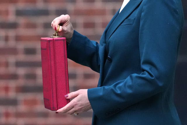 Chancellor of the Exchequer Rachel Reeves poses outside 11 Downing Street, London, with her ministerial red box (Frank Augstein/PA)